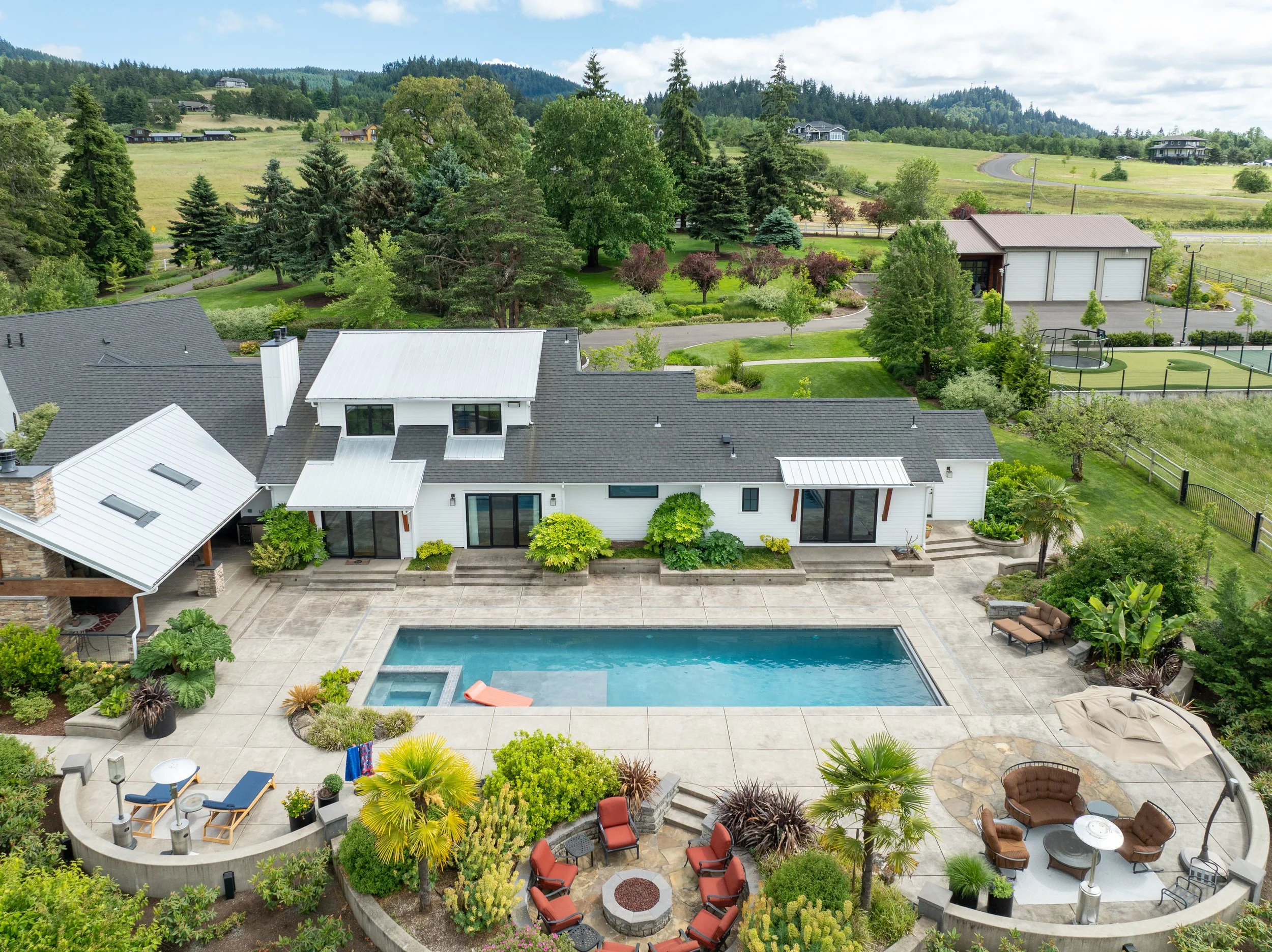 Drone photo of a luxury backyard with a pool