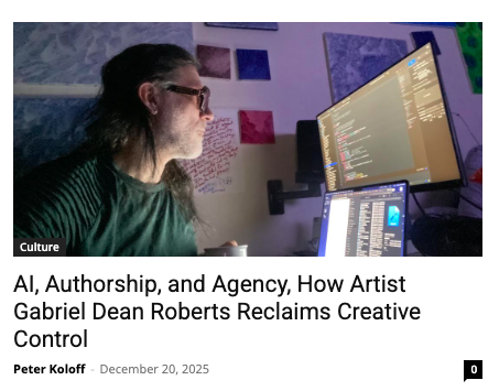 Acorn Mobile founder, Gabriel Dean Roberts works at dual computer monitors in a dimly lit room decorated with colorful paintings.