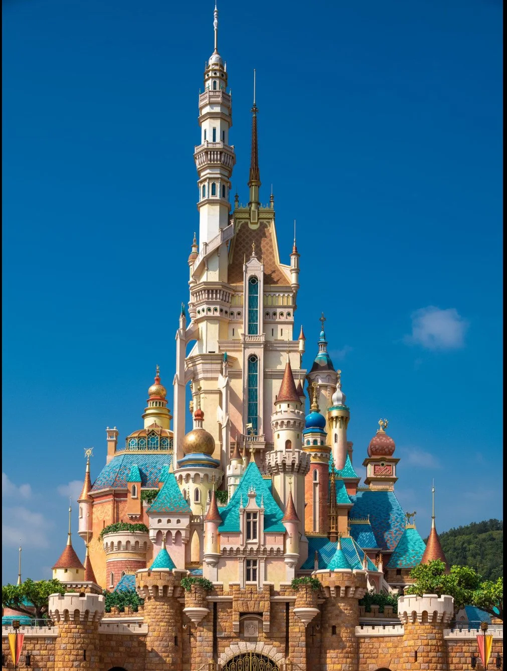 Disneyland's sleeping beauty castle with colorful turrets and stone walls under a blue sky.