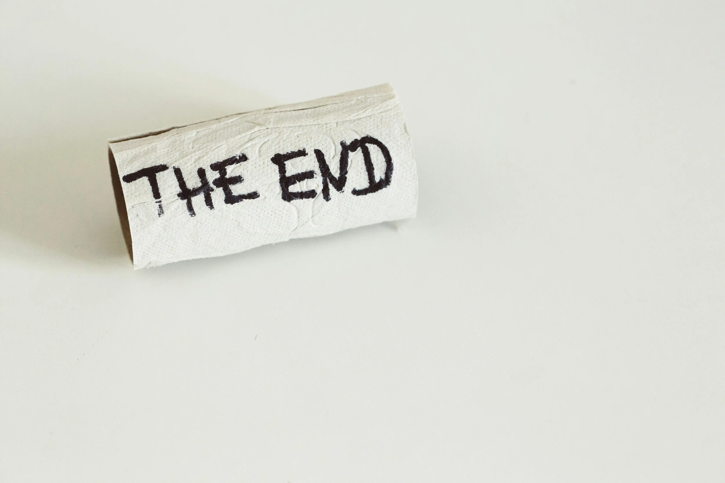 A crushed white paper napkin with the words 'THE END' written in black marker.