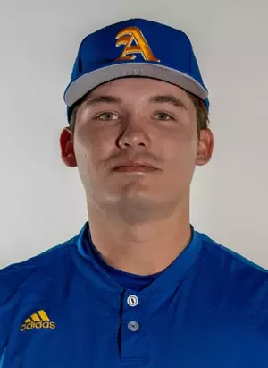 Portrait of a young man wearing a blue baseball cap with a yellow 'A', a blue sports jersey, and a neutral facial expression.