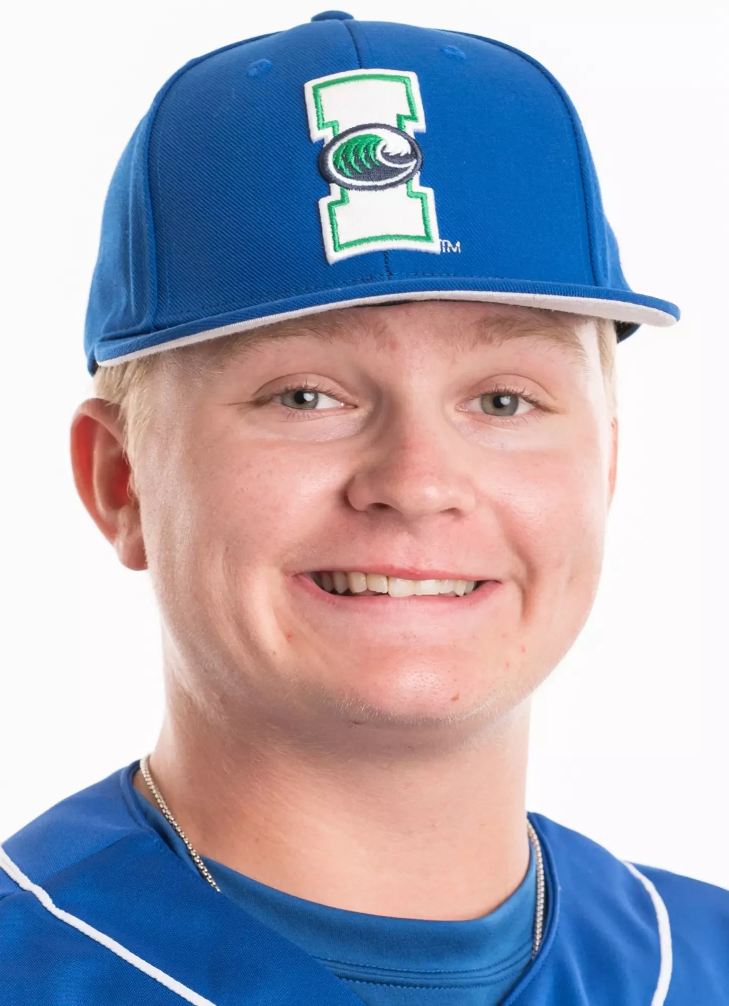 A young man wearing a Detroit Lions cap with a blue shirt, smiling at the camera.