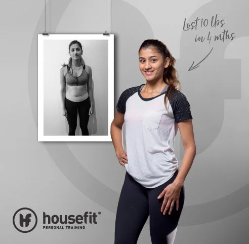 Before and after photo of a woman’s weight loss journey, showing a black-and-white photo of her in a sports bra and leggings hanging on the wall, and a smiling, fit woman in matching workout clothes standing in front of it, with a note saying "Lost 10 lbs in 4 months."