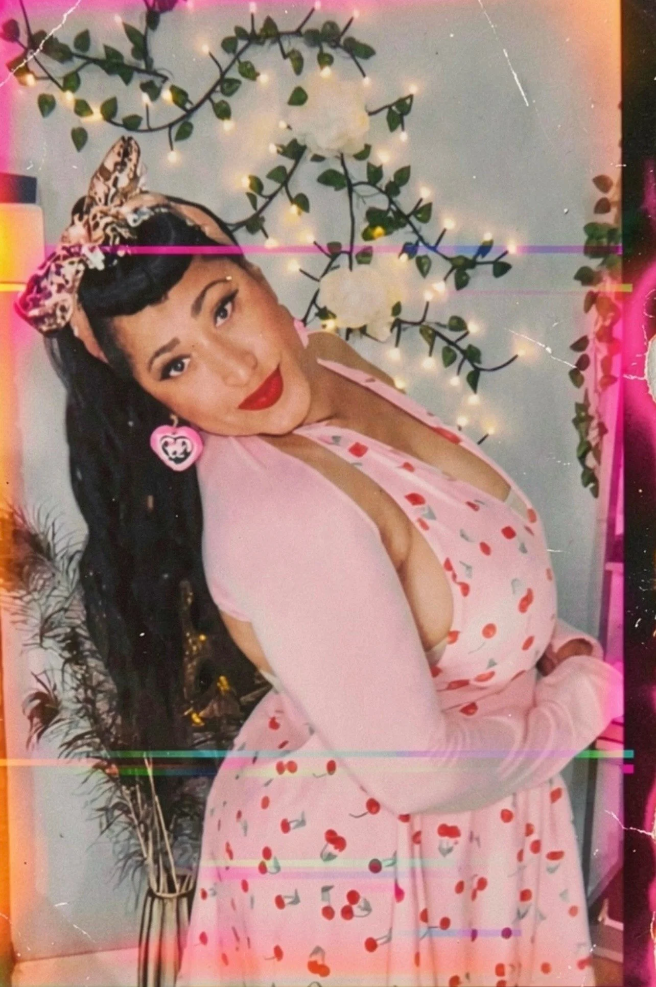 Erika Broussard, psychic advisor and intuitive guide, wearing a pink heart-print dress and red lipstick, styled in bold feminine energy.