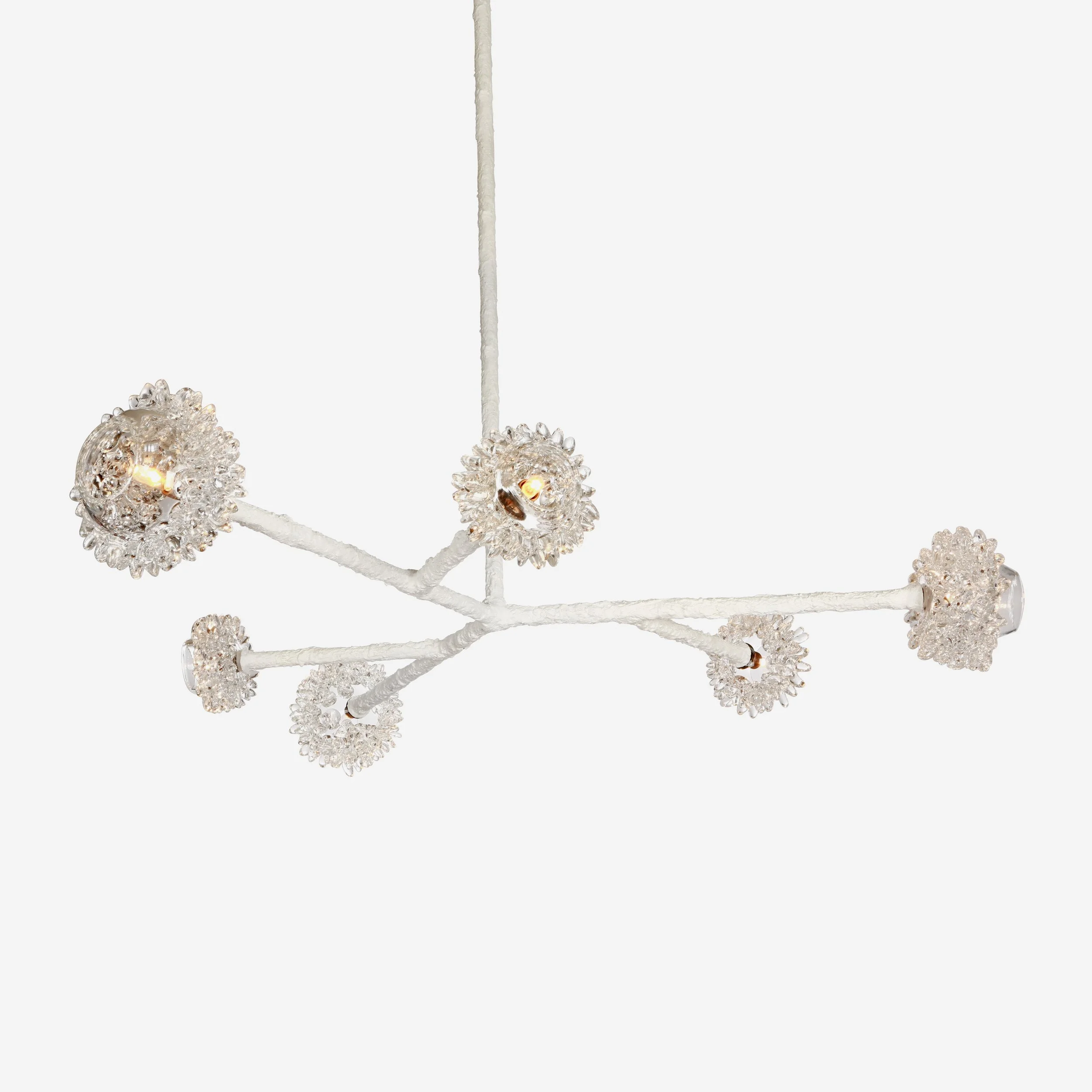 Modern chandelier with multiple small, flower-like light fixtures arranged on white branches.