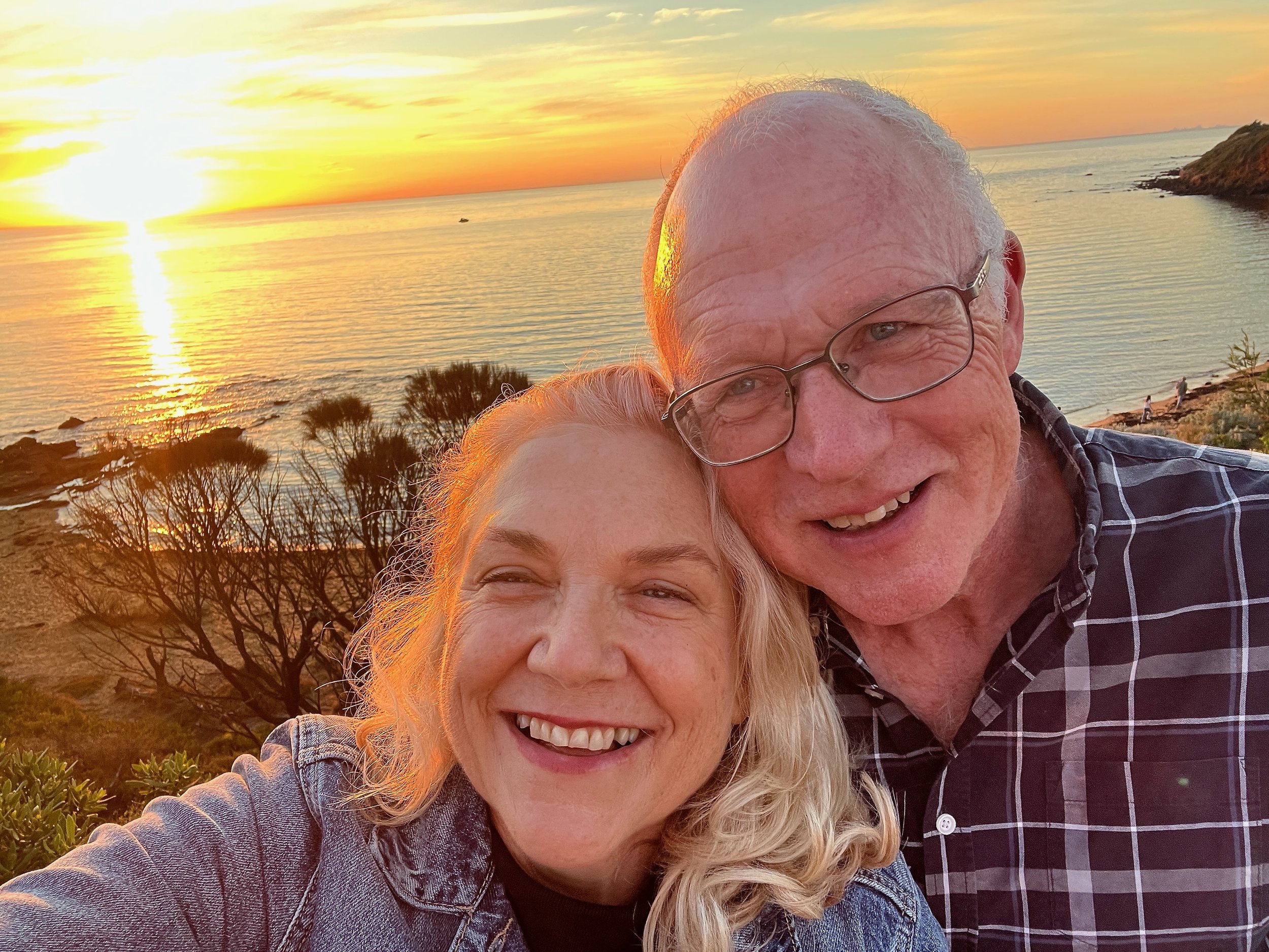 Joanna Wood and her partner Bruce smiling at sunset on the coast — a story about intentional dating in midlife.