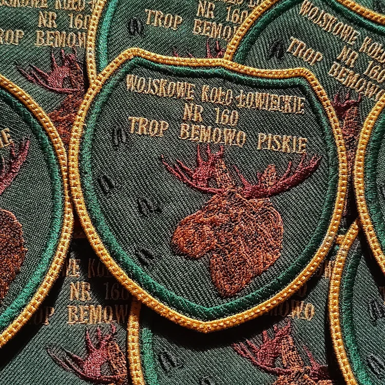 Green Military Hunting Club No. 160 Trop, Bemowo Piskie patches with gold edging and an embroidered moose head.