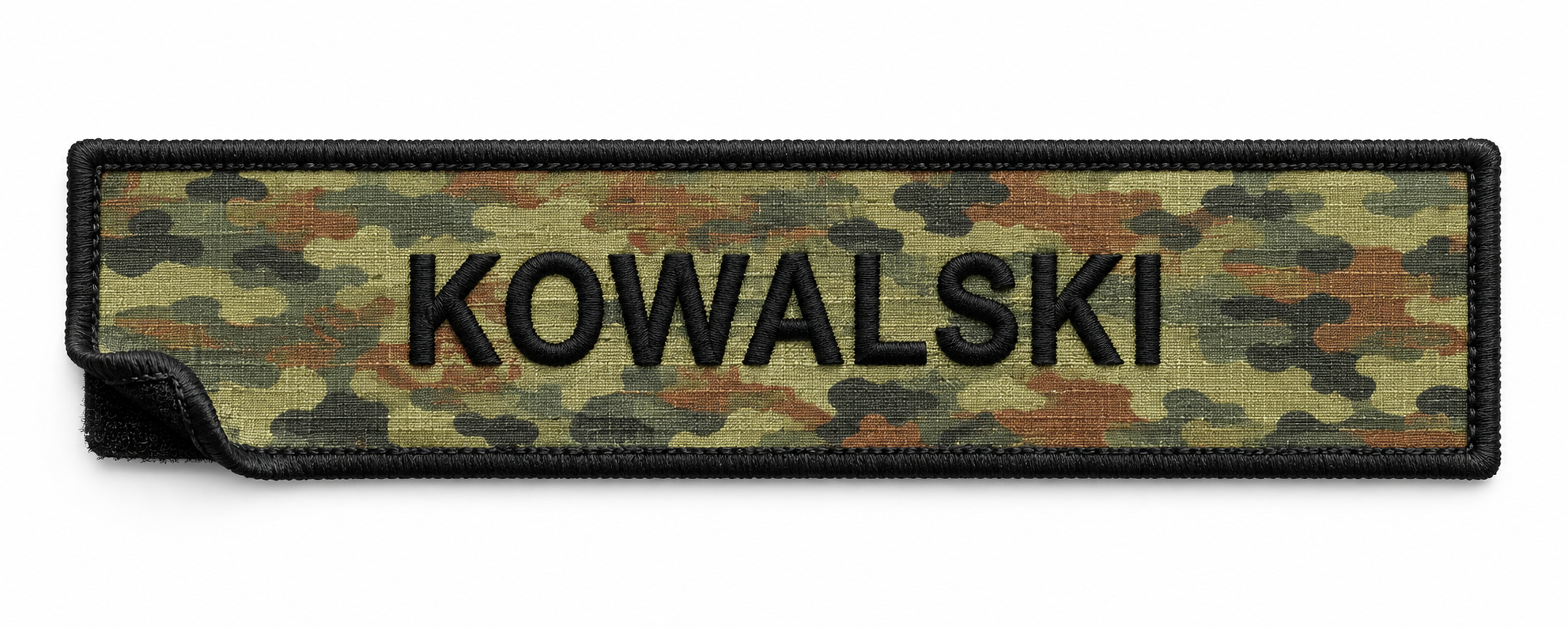 Military-style fabric name tape with the name 'KOWALSKI' embroidered in black on a camouflage background.