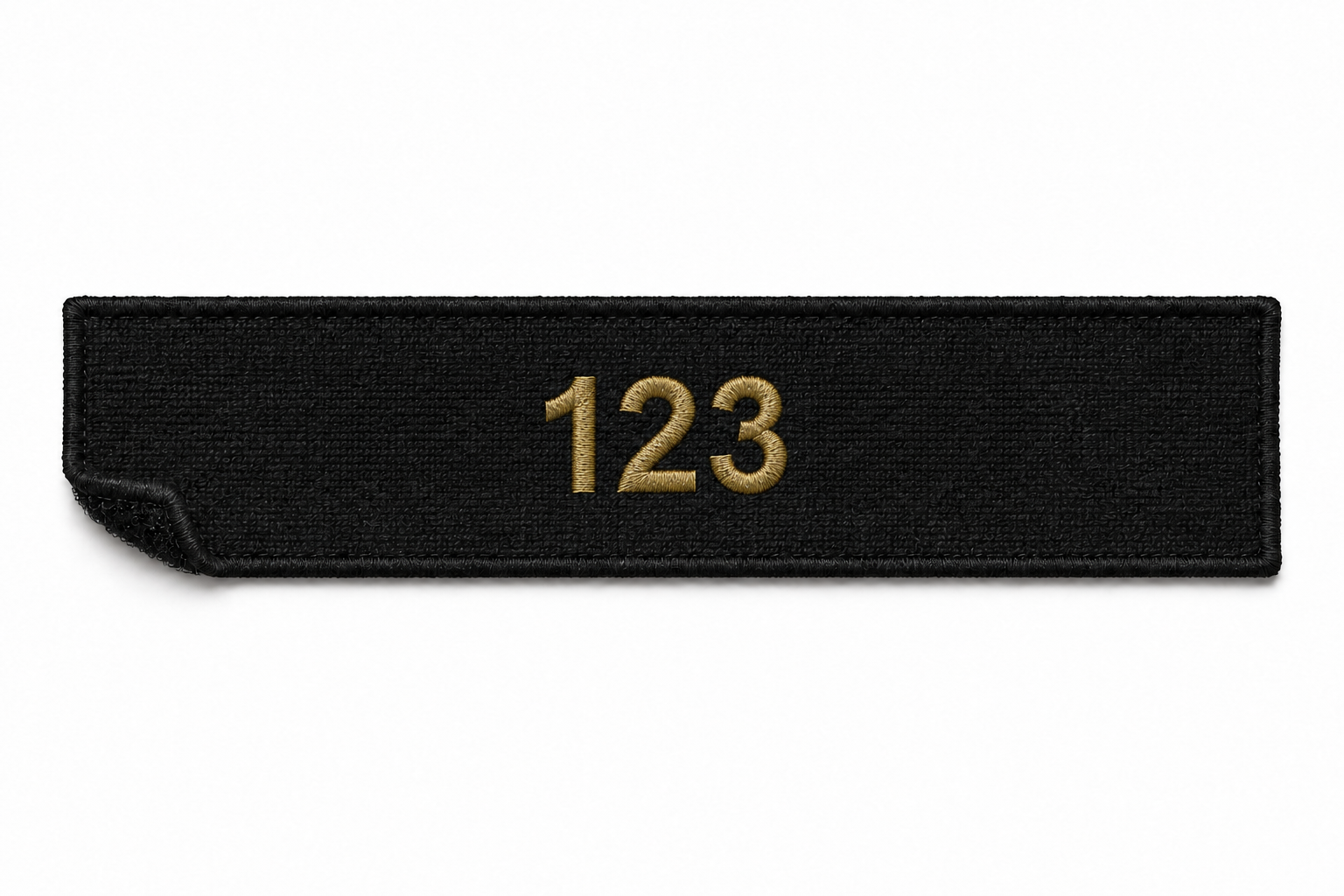 Black fabric badge with the gold embroidered number 123.