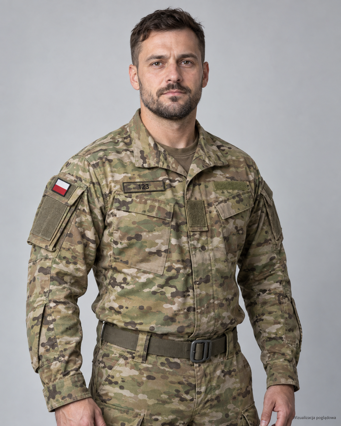 A man in military camouflage uniform with a Polish flag patch on his right shoulder, standing against a plain gray background.
