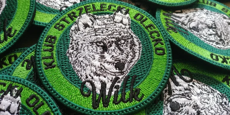 Green Olecko Shooting Club patches featuring a finely embroidered wolf head.