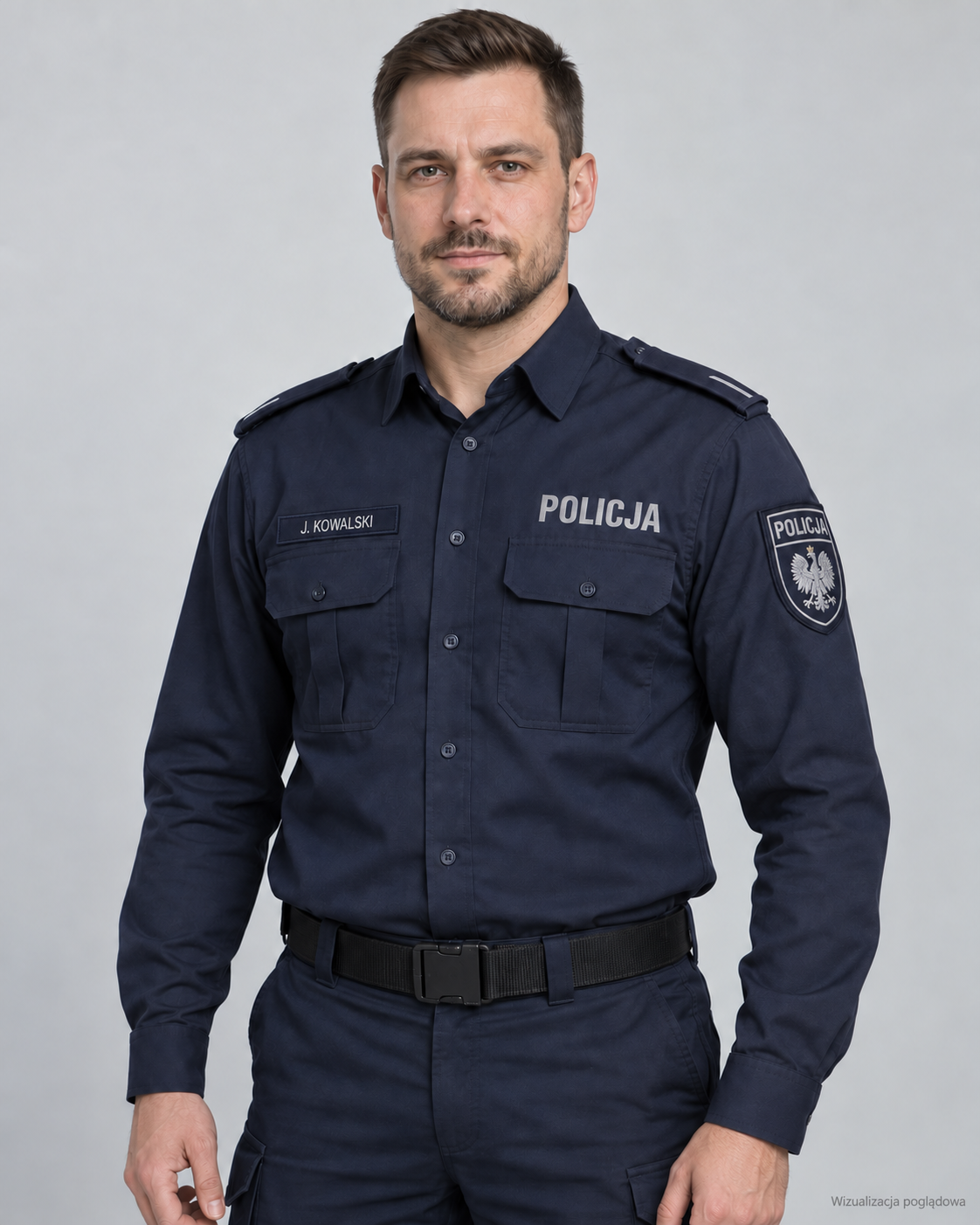 Portrait of a male police officer in uniform, with the name tag J. Kowalski, wearing a navy blue shirt with police insignia, against a plain background.