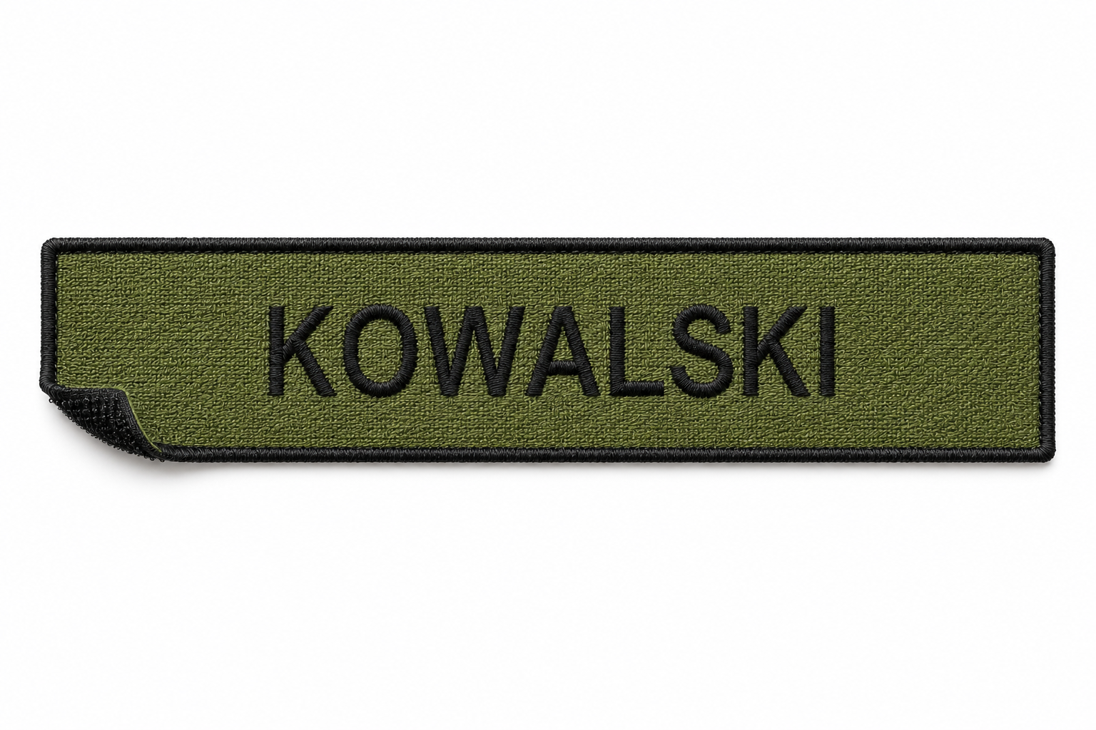 Green military-style patch with black border and the word 'KOWALSKI' embroidered in black.
