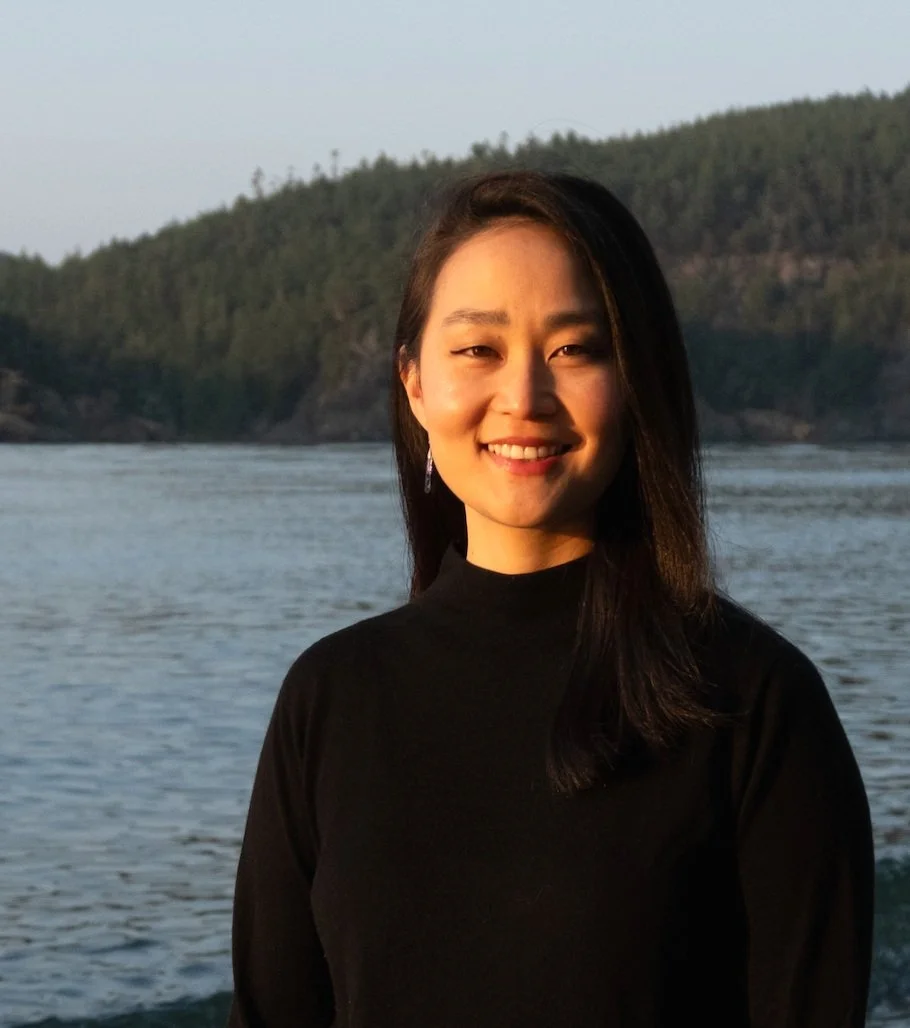 Psychiatric provider outdoors near a calm natural shoreline