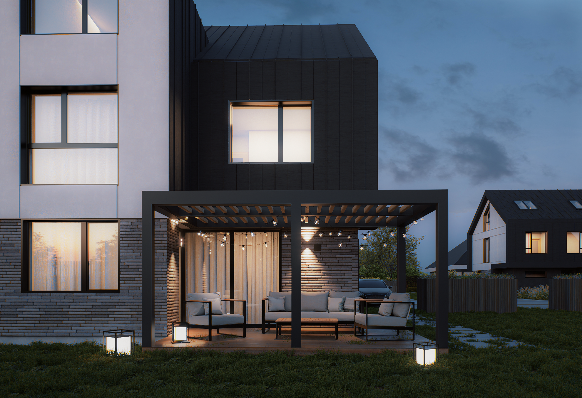 Nighttime exterior view of a modern house with a covered patio, outdoor seating, string lights, and a lawn.