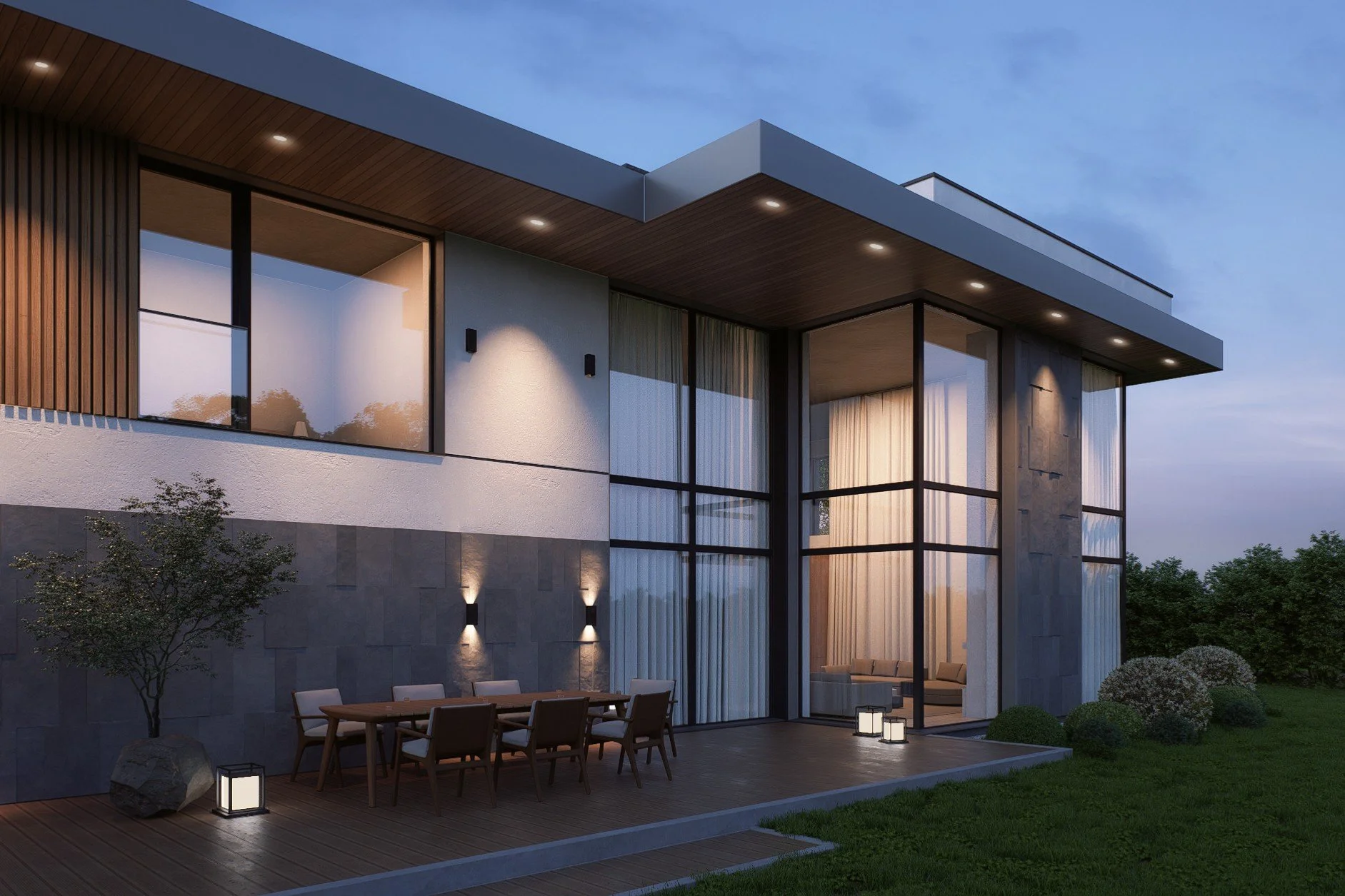 Modern two-story house with large glass windows, outdoor patio with dining table, surrounding greenery, and exterior lighting at dusk.
