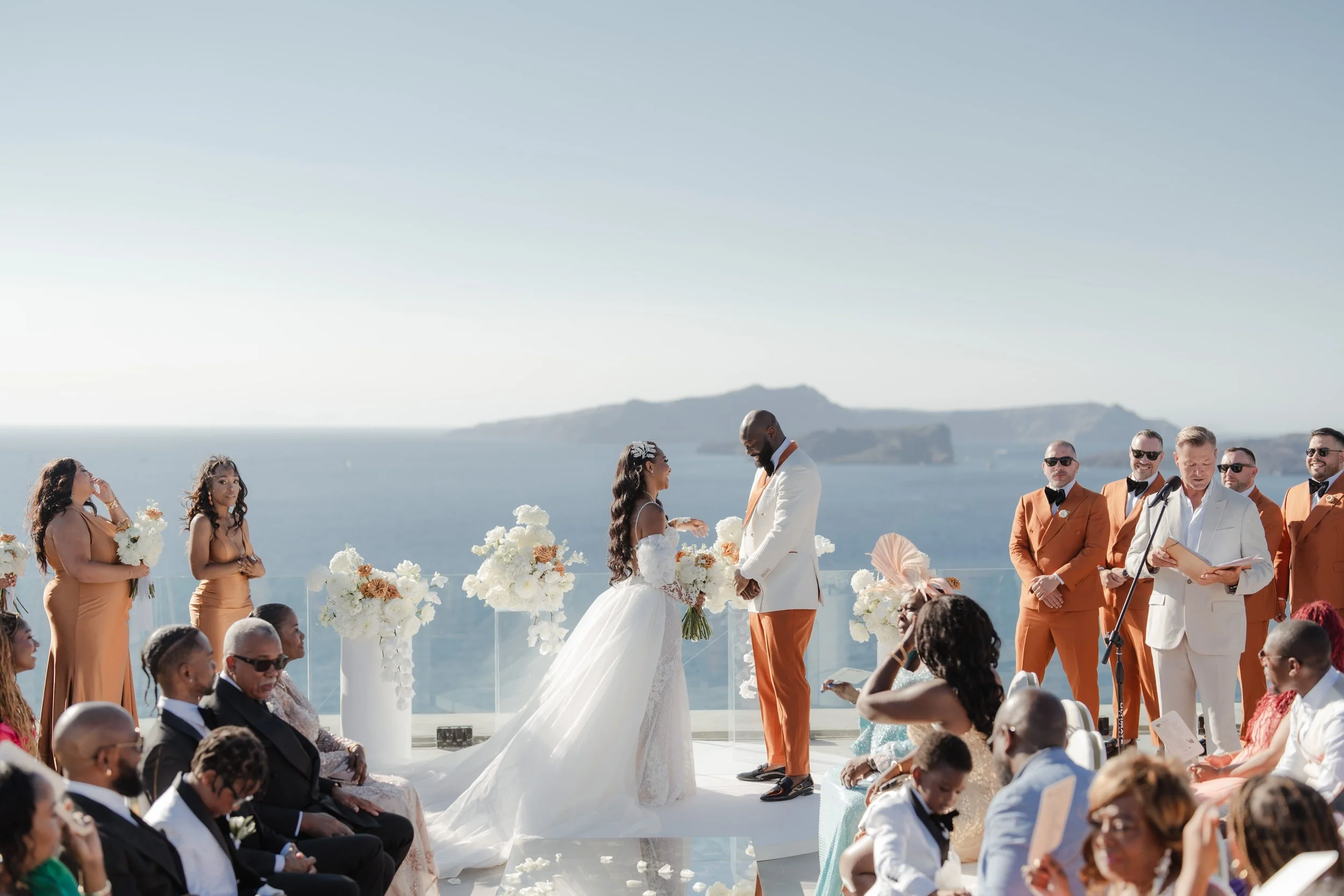 Luxury Destination Wedding in Santorini, Greece
The bride and groom exchange vows surrounded by family and friends in Santorini. A heartfelt moment that defines the elegance of a luxury destination wedding in Greece.