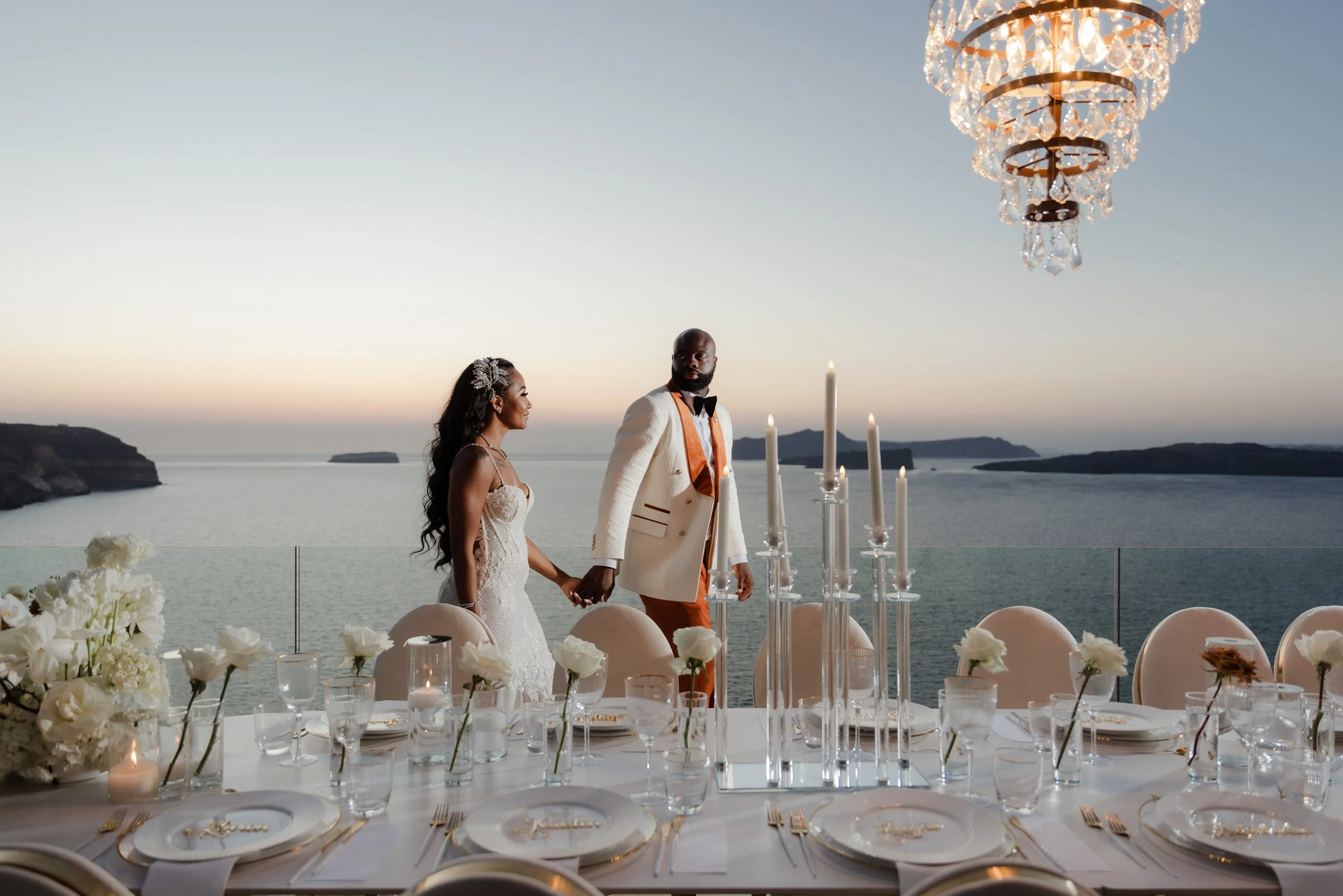 Luxury Wedding Reception with Chandeliers in Greece
The couple walks through their dinner reception in Santorini, surrounded by chandeliers and elegant décor. A sophisticated highlight of a luxury wedding in Greece.