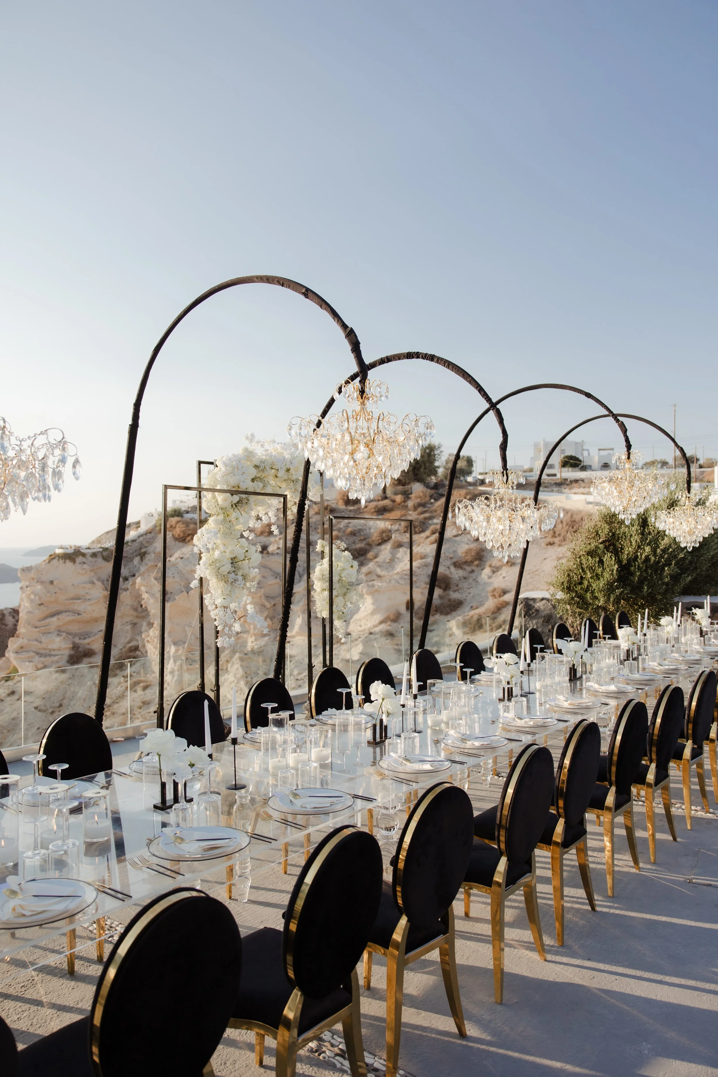 Luxury Wedding Lighting Design in Santorini, Greece
Dramatic chandeliers suspended over a poolside walkway create a glamorous atmosphere in Santorini. A striking detail of luxury wedding design in Greece, blending modern elegance with island beauty.