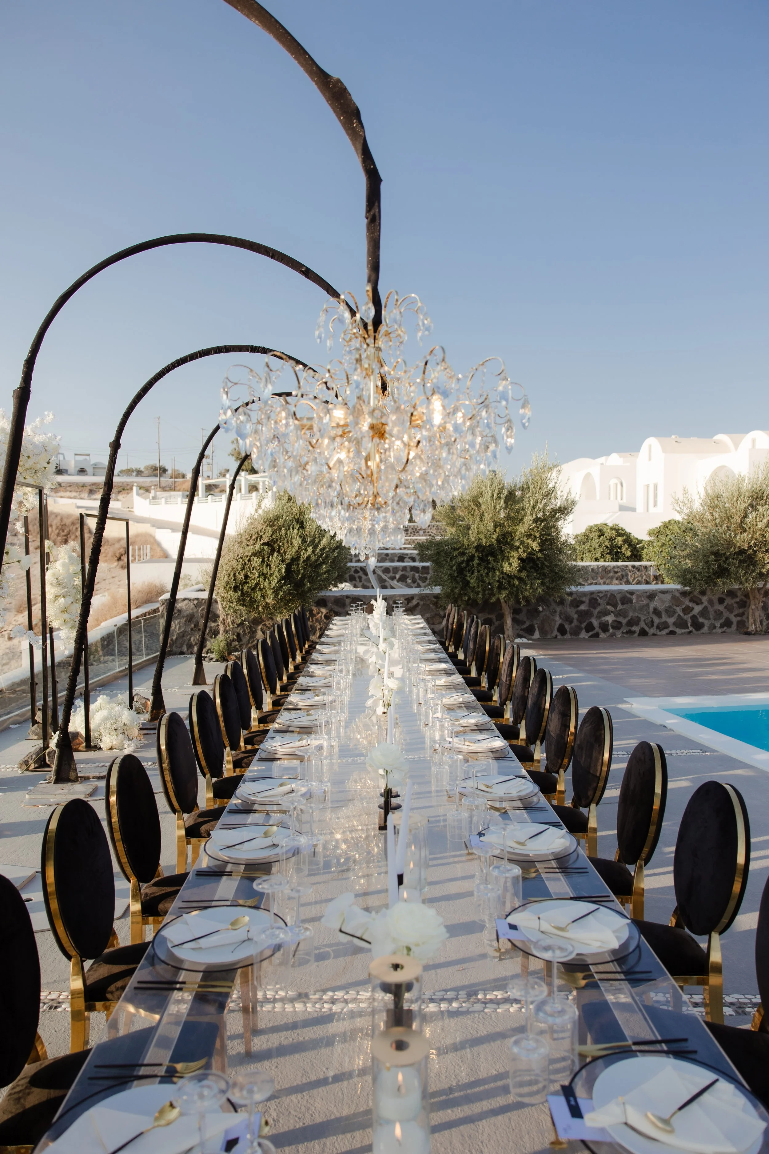 Luxury Wedding Reception in Santorini, Greece
A breathtaking long table reception under cascading chandeliers in Santorini. Golden details, refined styling, and the Greek island backdrop create an unforgettable luxury wedding experience.