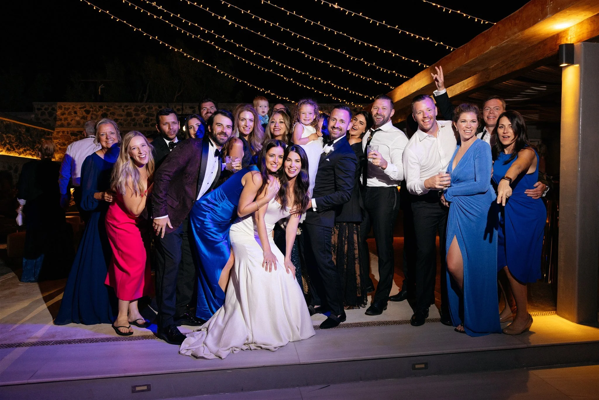 Luxury Destination Wedding in Greece
The wedding party gathered in Santorini, celebrating under the night sky. A portrait of joy, elegance, and togetherness that defines a luxury destination wedding in Greece.
