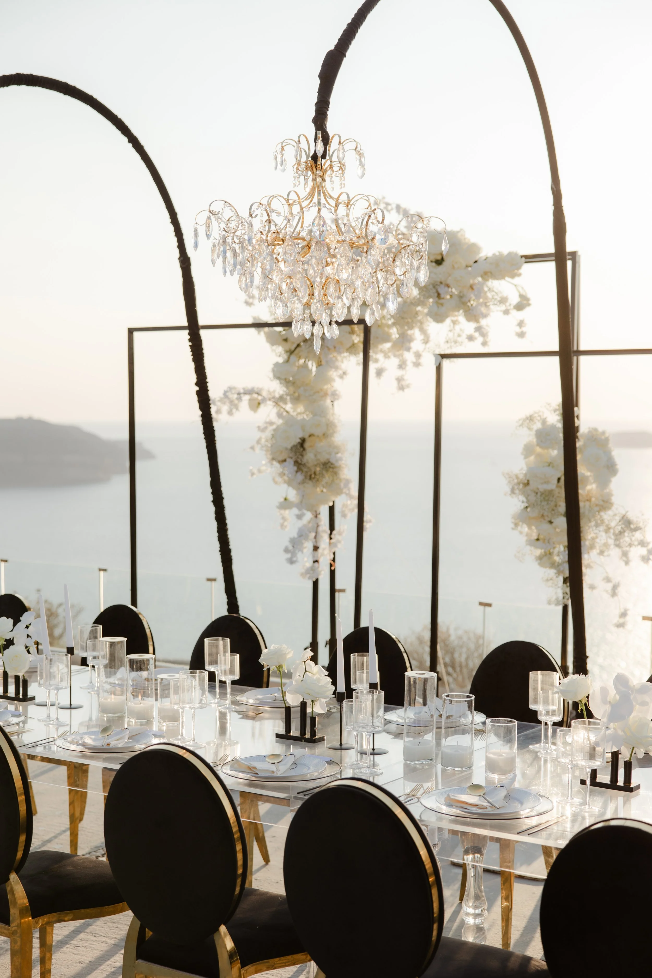 Luxury Wedding Reception in Greece
An exquisite table setup featuring chic florals, crystal chandeliers, and modern elegance. A perfect example of luxury wedding design in Santorini, Greece.