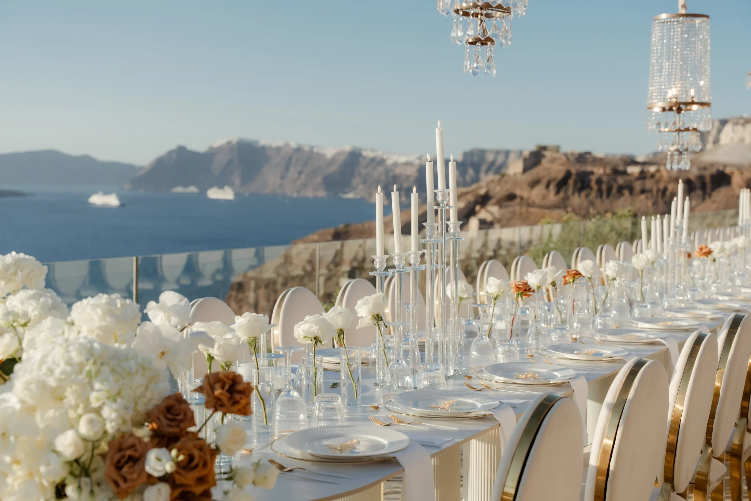 Luxury Wedding Décor in Santorini, Greece
An elegant reception design featuring crystal chandeliers, chic florals, and golden tableware. A signature look of a luxury wedding celebration in Greece.