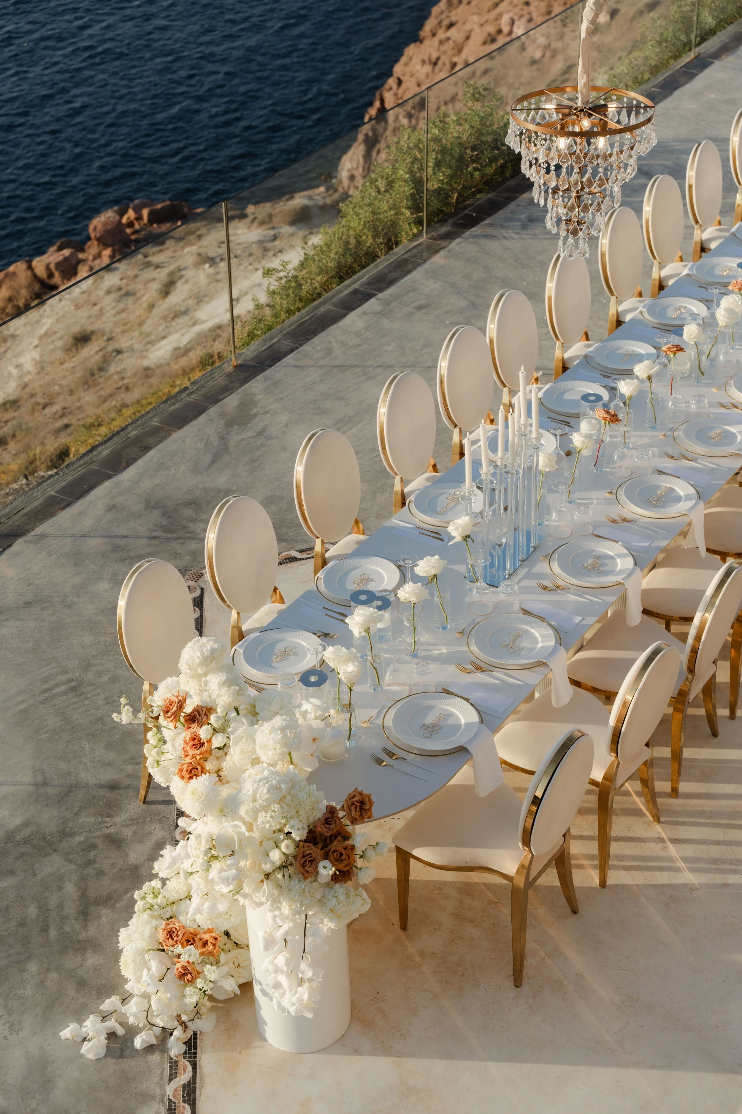 Luxury Wedding Reception Table in Santorini, Greece
An extraordinary long table reception overlooking the sea in Santorini. Elegant décor, white florals, and golden accents define this luxury wedding in Greece.