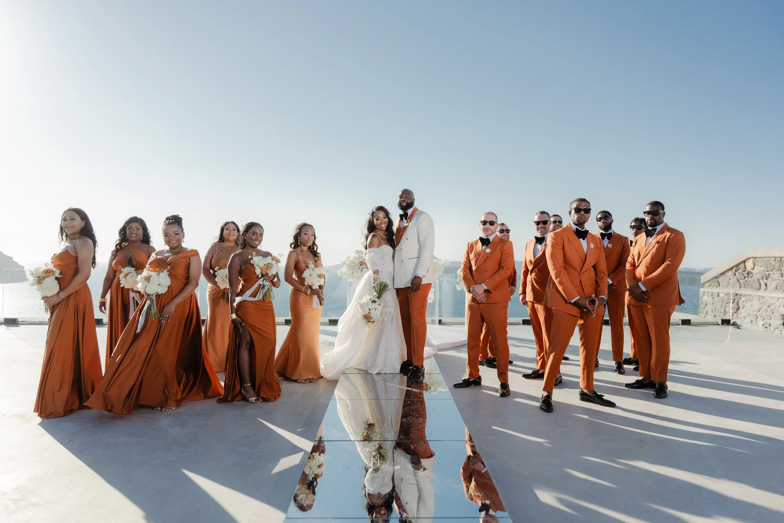 Luxury Wedding Party in Santorini, Greece
The couple pose with their stylish wedding party, creating a striking portrait filled with elegance and joy. A signature highlight of a luxury wedding in Greece.