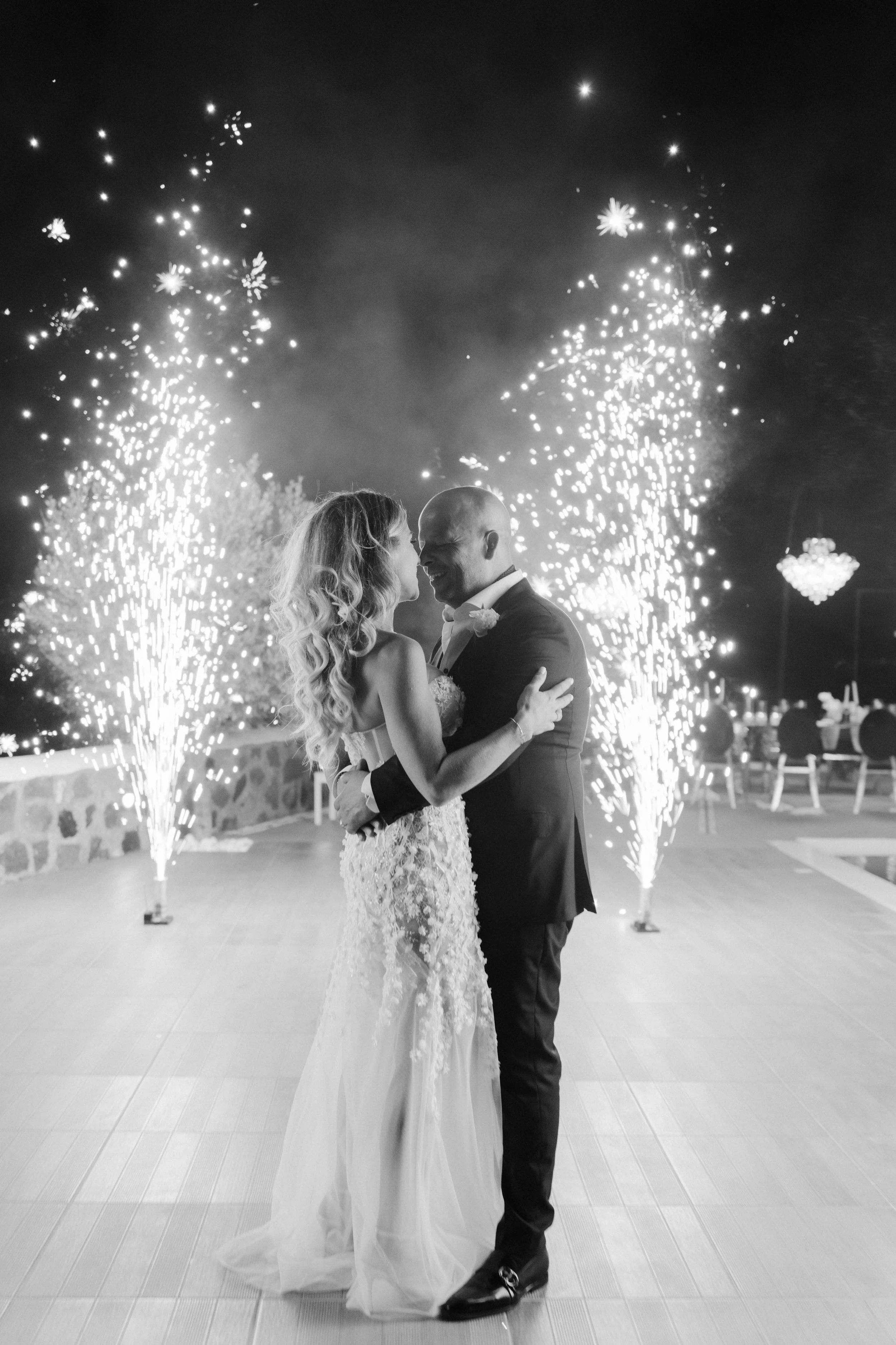 Luxury Wedding First Dance in Santorini, Greece
The newlyweds share their first dance surrounded by sparkling fireworks in Santorini. A magical and glamorous moment that defines the essence of a luxury Greek island wedding.