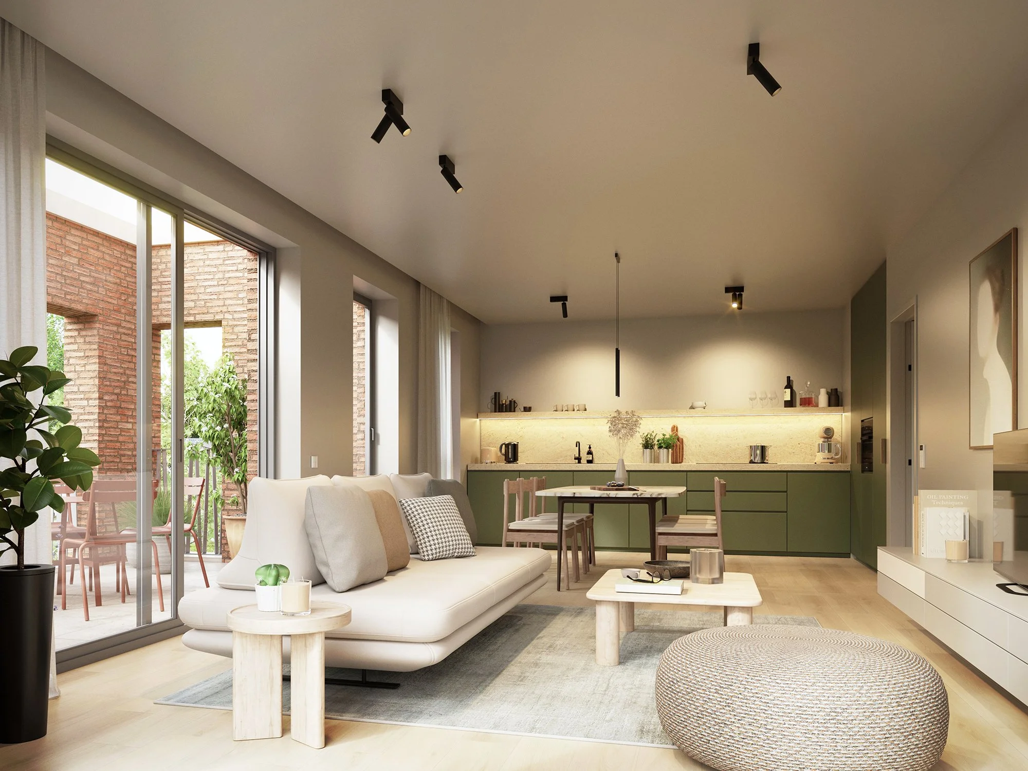 Een moderne woonkamer met grote ramen die uitzicht geven op een tuin. Er staat een witte bank met kussens, een ronde salontafel, een lage groene keuken met kopjes en andere keukenspullen. Er is ook een grote gestoffeerde poef en een boekenkast met bo
