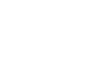 Silhouette of a person reading a book or document at a desk.