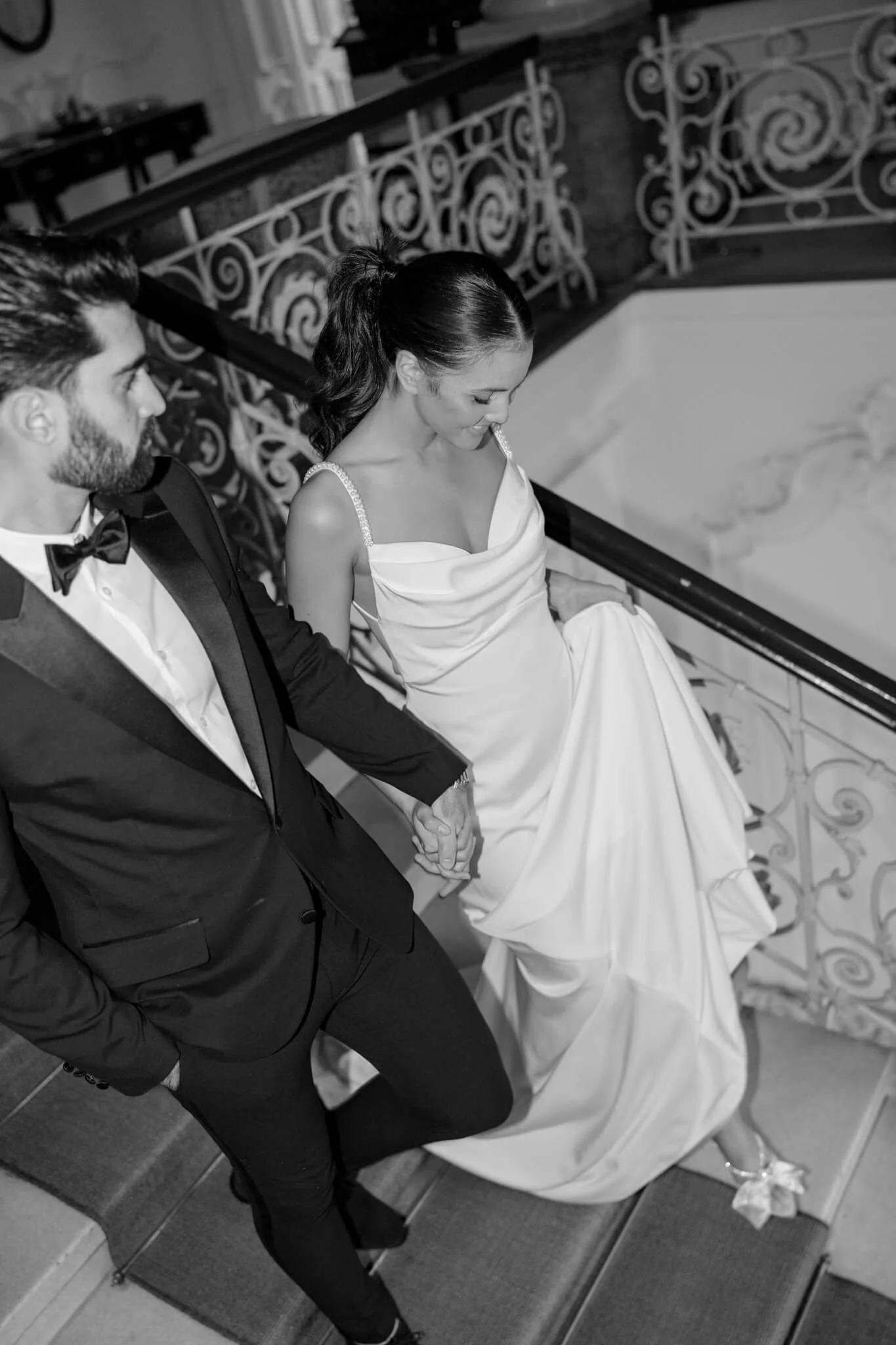 Bride and groom walking down staircase at elegant destination wedding in Italy