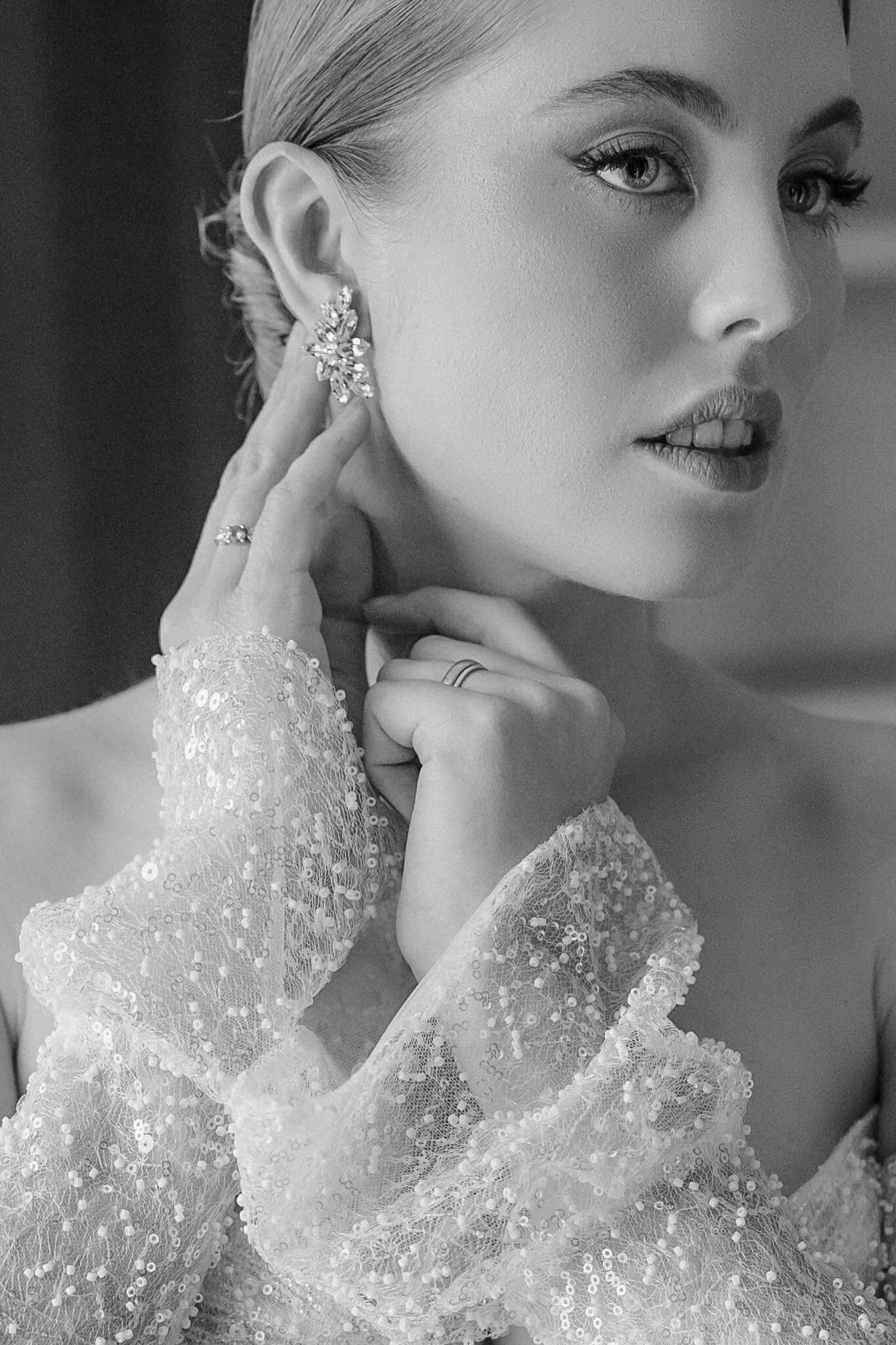 Close-up bridal portrait with earrings and sequined gown by destination wedding photographer Tuscany