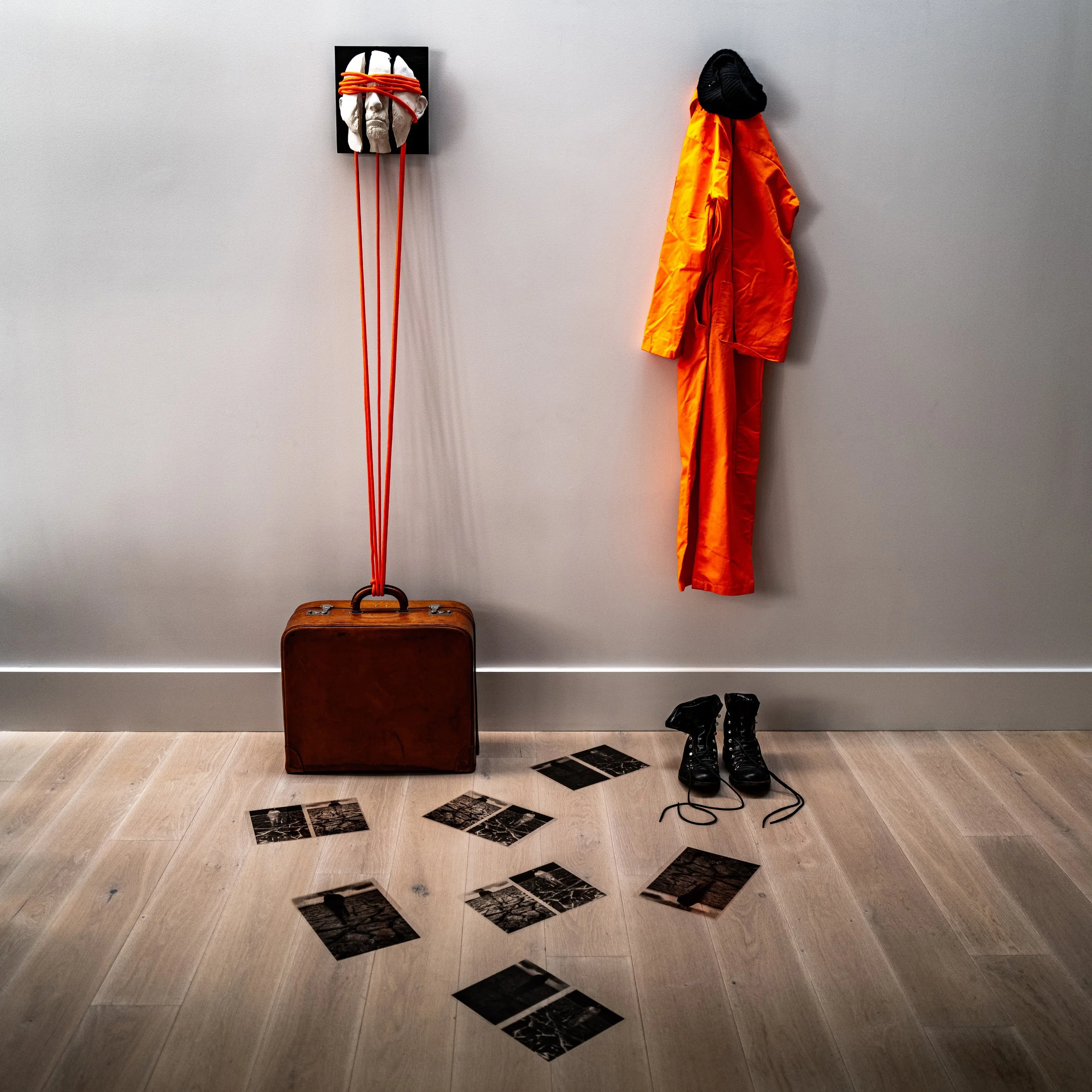 Tripartite, (2024). Installation #3.
Sculpture in three pieces with binding ropes anchored to leather suitcase, discarded film negatives and expedition clothes.
2 x 2 x 2 m