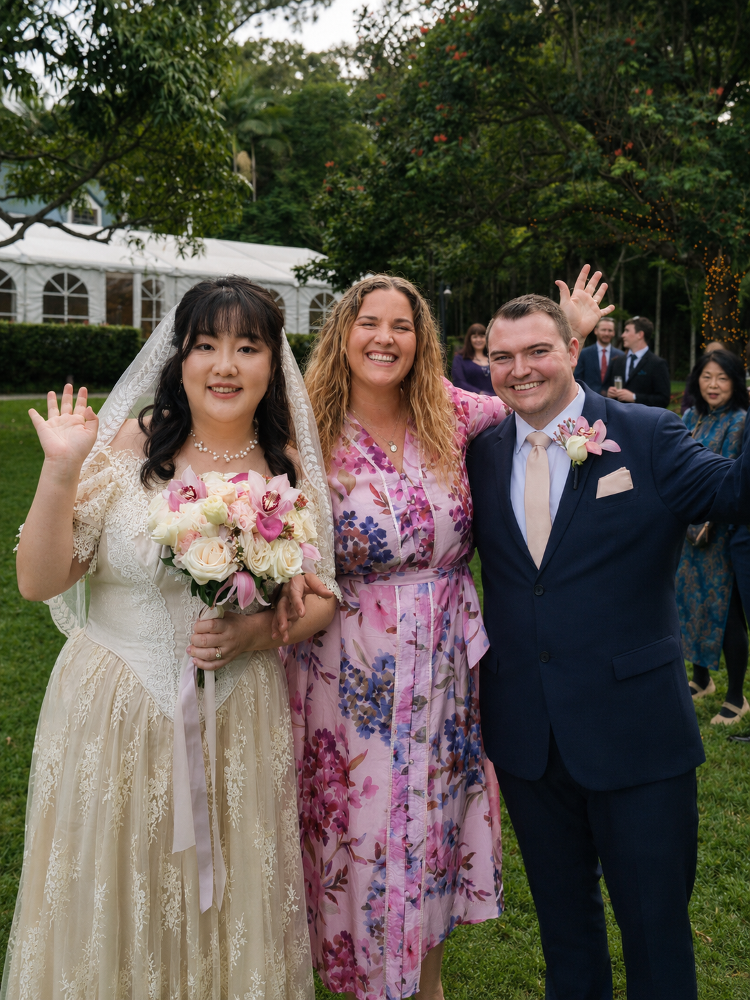 Celebrant laughing and waving with wife and husband