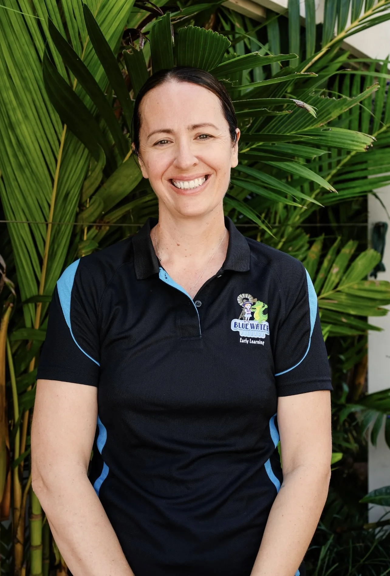 A smiling woman who is a childcare educator