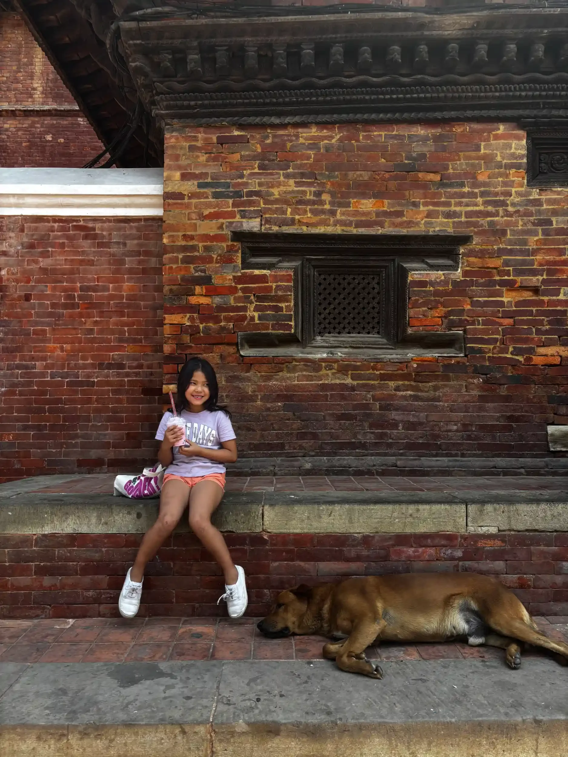 Local girl with a street dog in Kathmandu