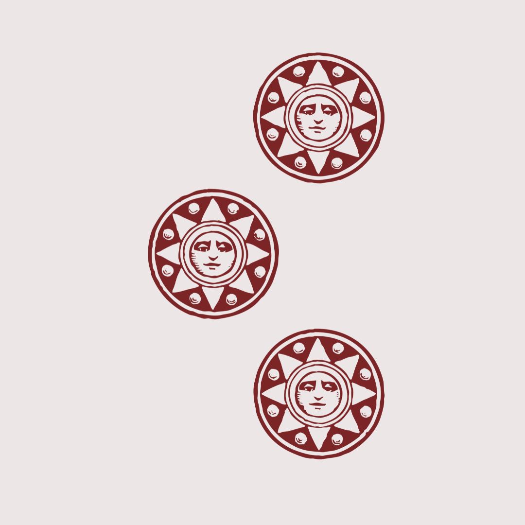 Three round decorative tokens or medallions with a face at the center, surrounded by a star-like shape and small circular elements, all in a dark red or maroon color on a light background.