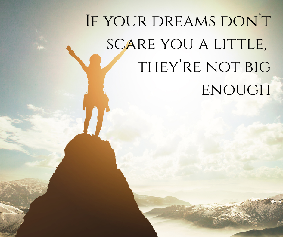 Person stood on top of a mountain