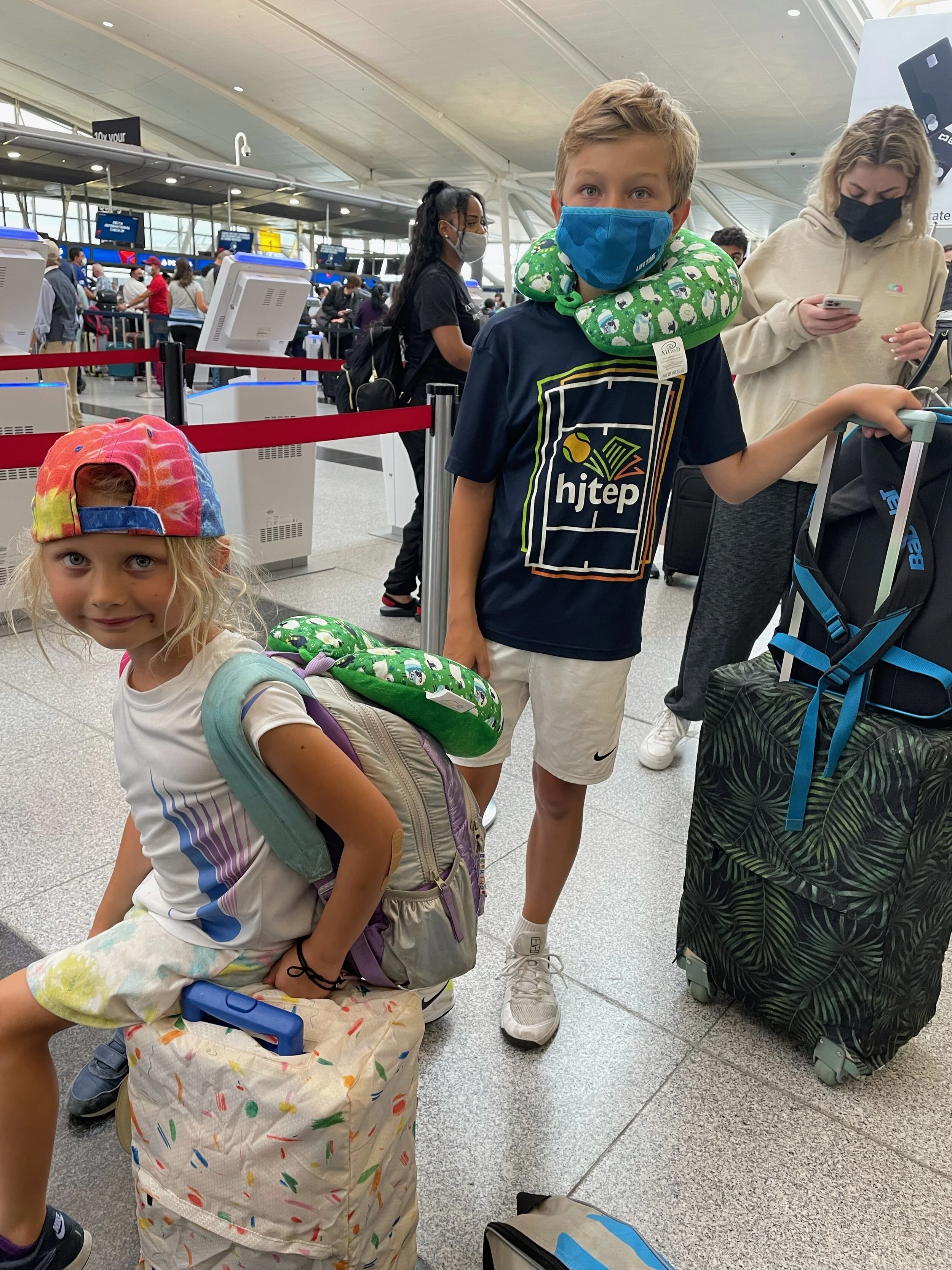 Picked up from tennis camp and plunged into an overnight flight, these kids are both insanely lucky and legitimately learning to be good travel troopers.