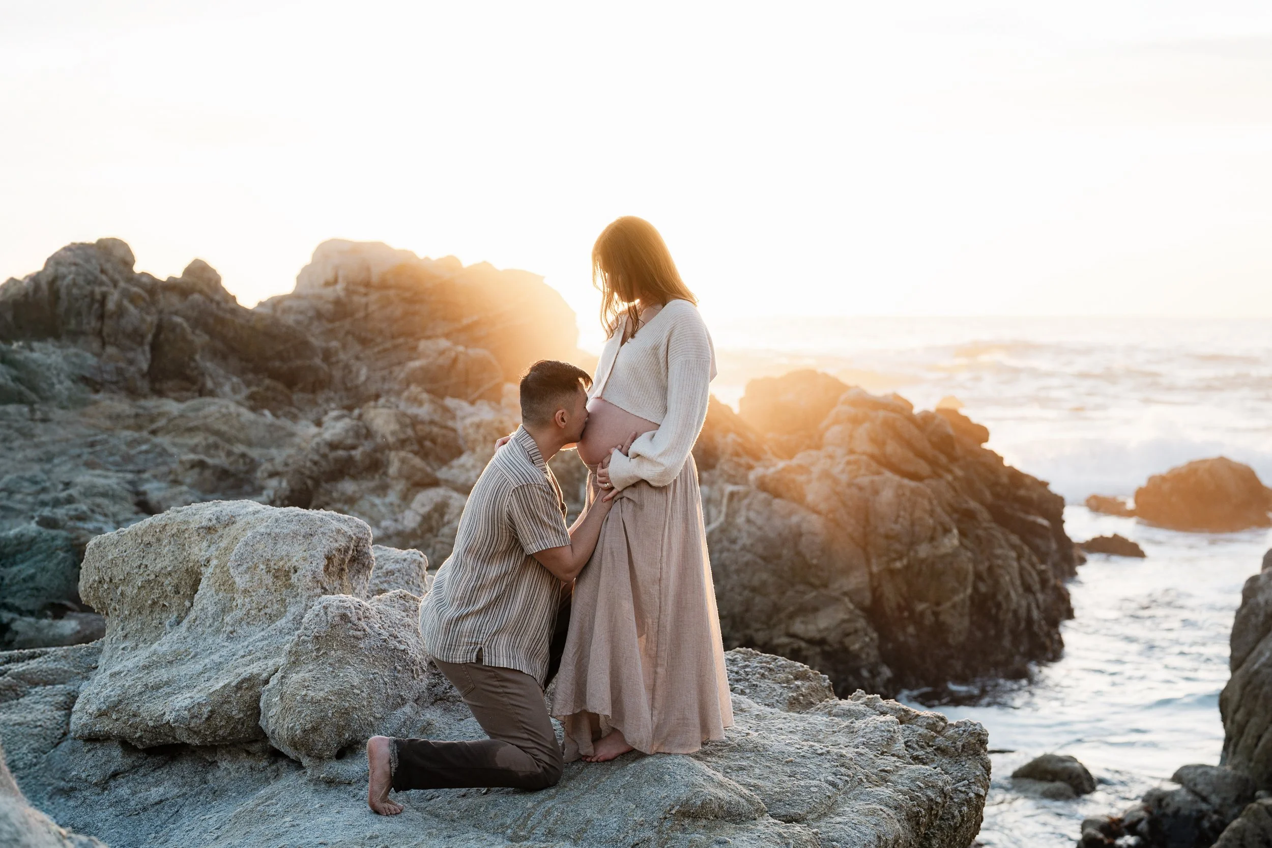 the dad is kissing the belly of the mom for a maternity photography in Carmel.