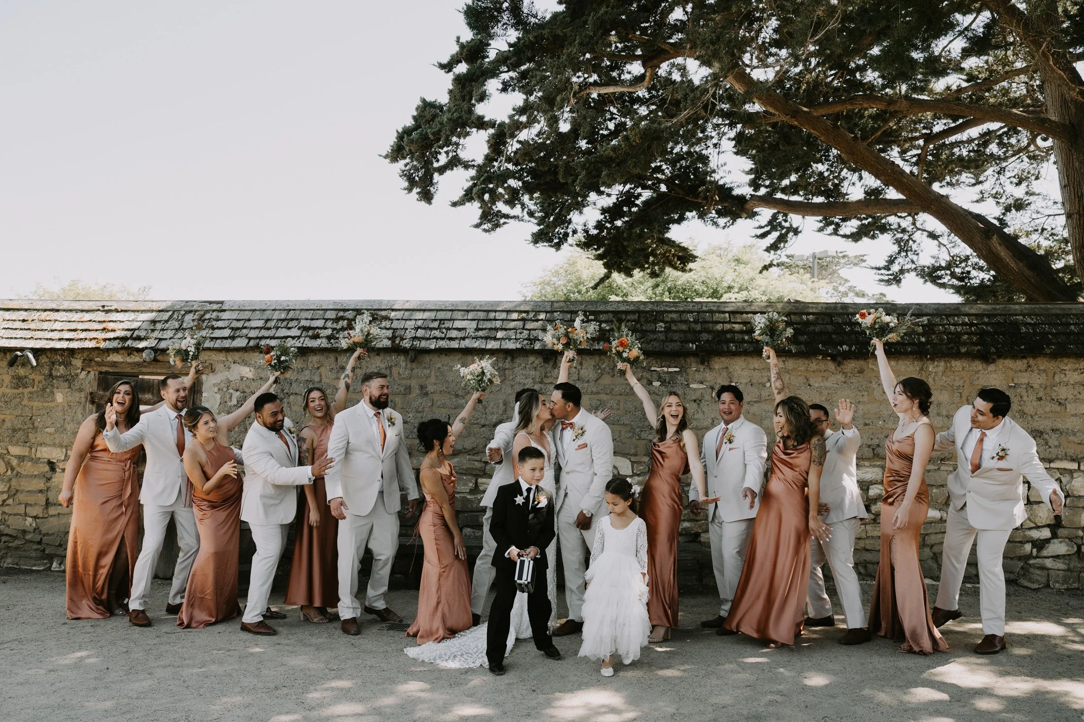 Wedding photography in Carmel where the wedding party is cheering up for the bride and groom.