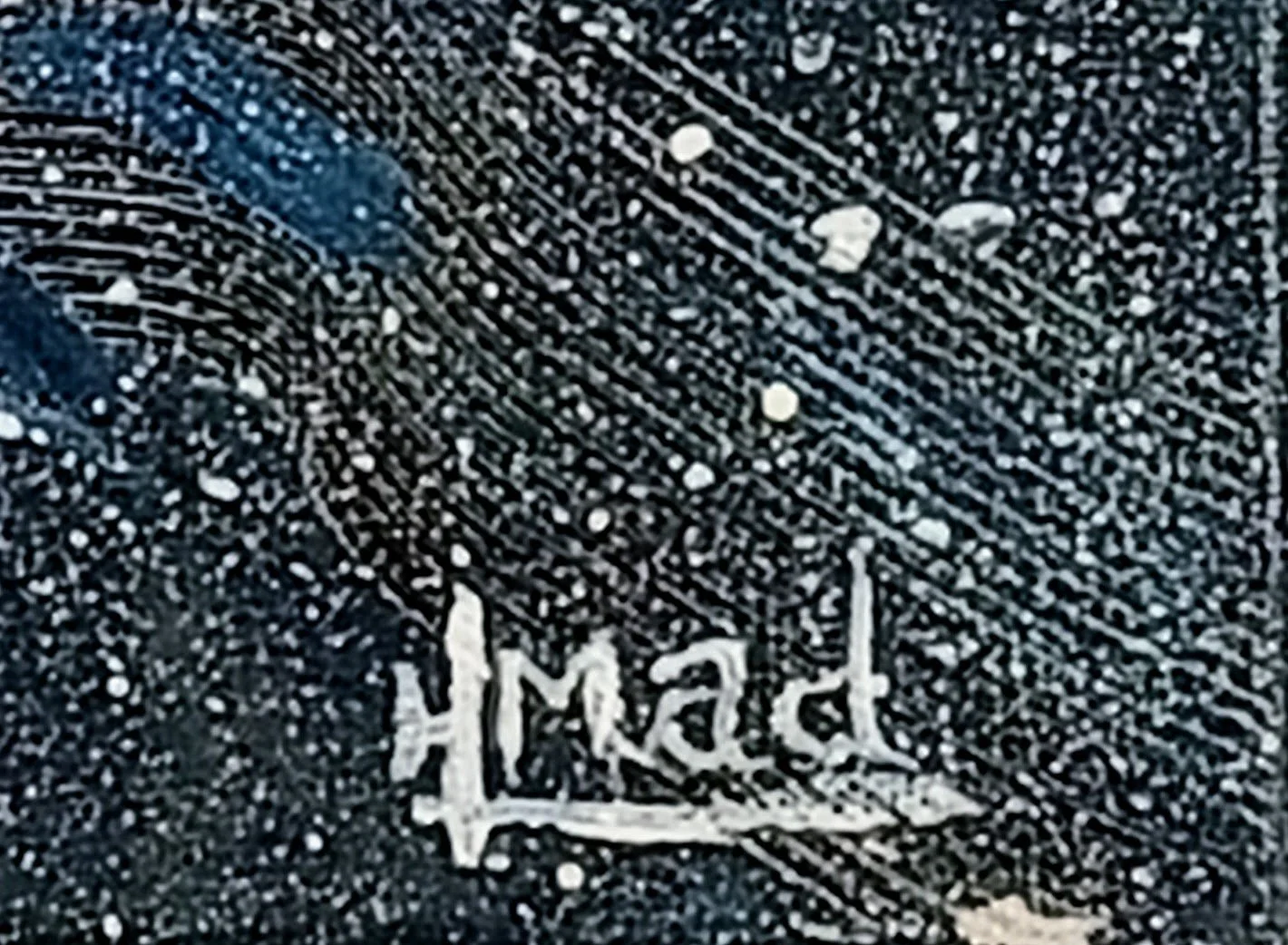 Signature of artist HMad on the lower right corner of the painting Feeling Blue, in white paint over a textured dark blue background.