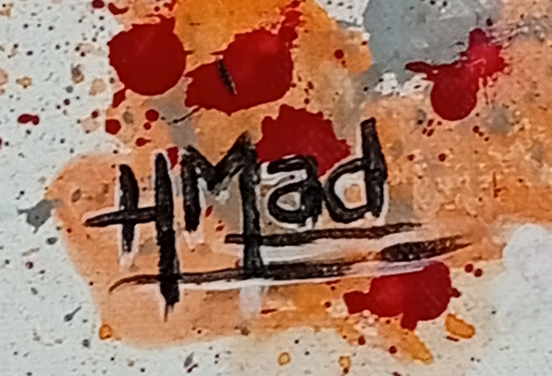 Artist HMad's signature on the painting "Slave Girl", over a background with red and orange paint splashes.