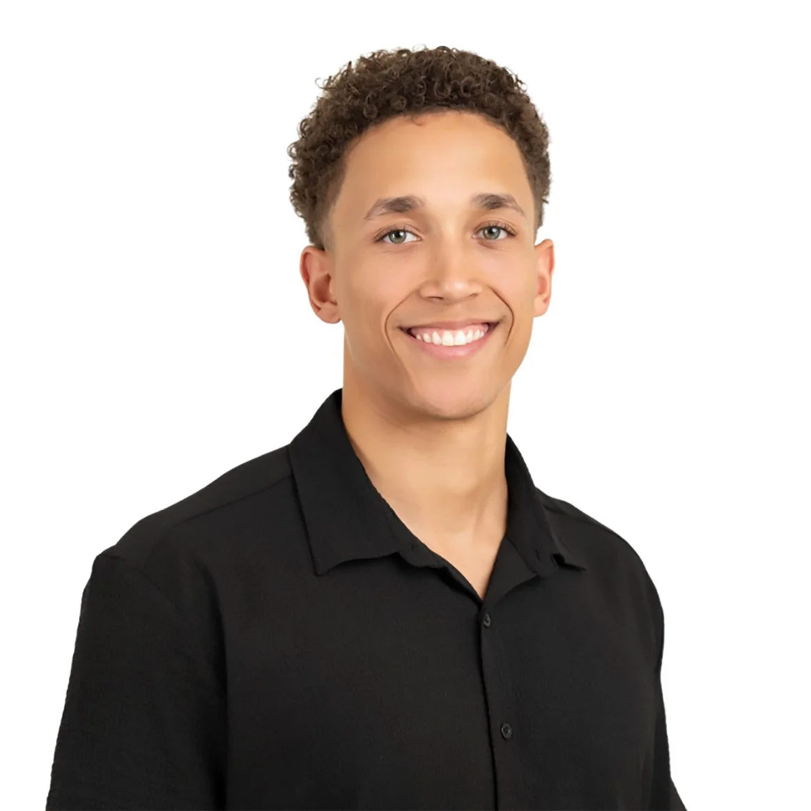 Smiling young man with short curly hair wearing a black button-up shirt poses against a white background.