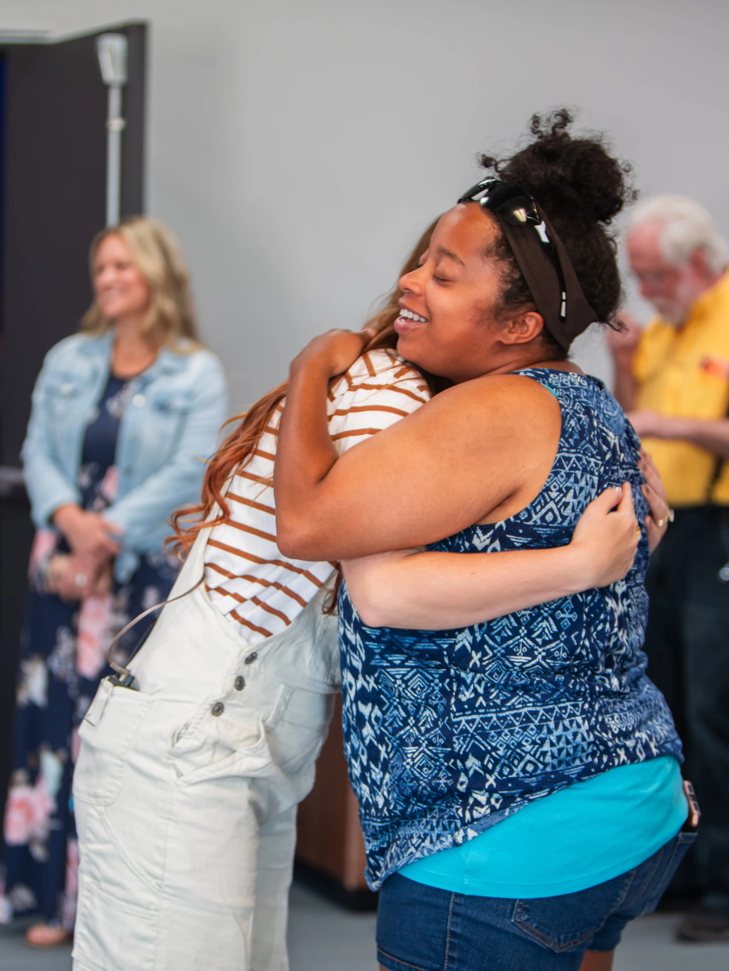 Two people embrace during a GNCO gathering.
