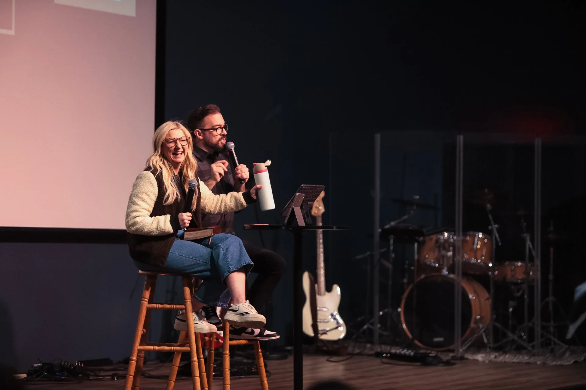 Two GNCO leaders sit together with a Bible.