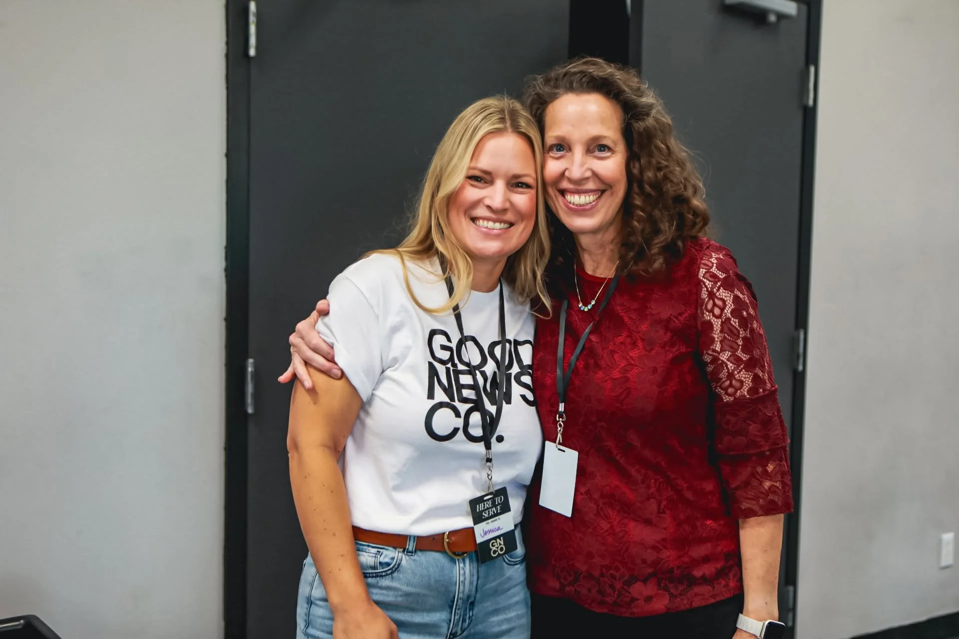 Two women smiling together at Good News Co.