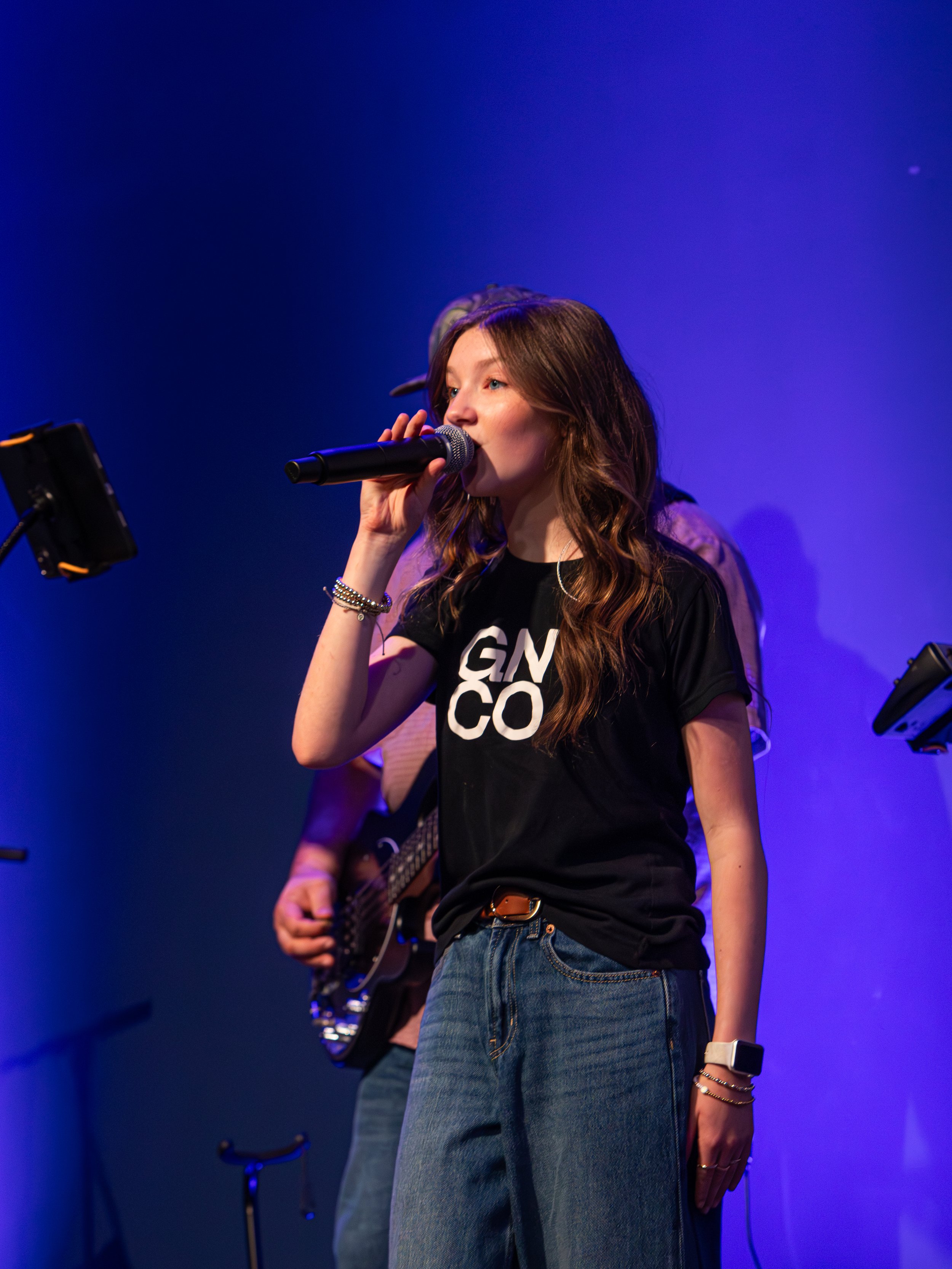 A young woman leading worship at Good News Co.